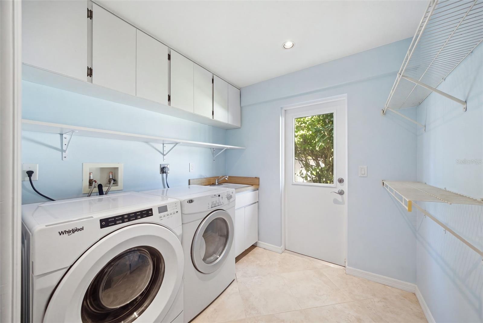 Laundry Room with Storage and Exterior Exit.