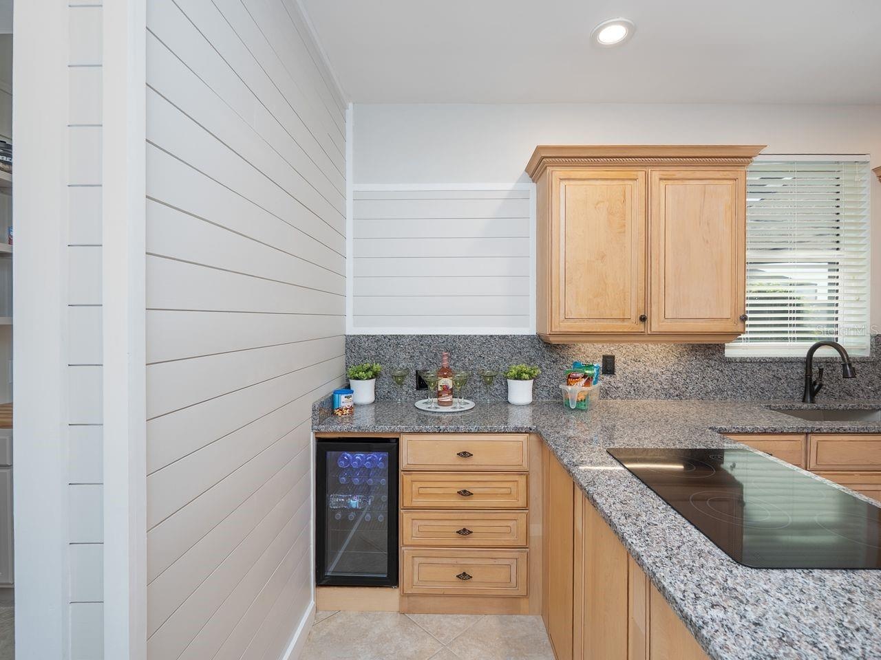 Wine frig in kitchen with pretty ship lap wall accent