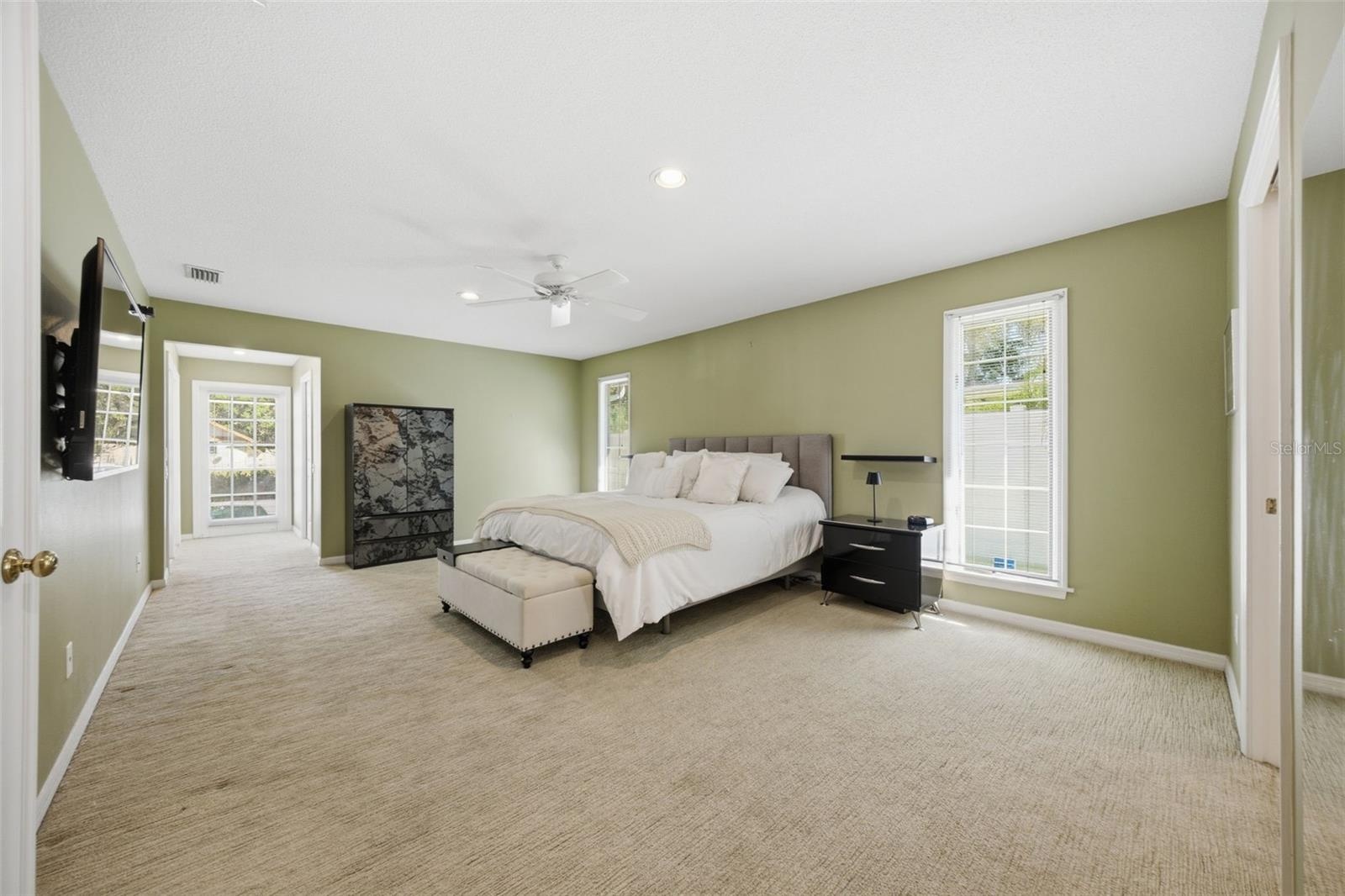First Floor - Primary Suite offers two walk-in closets and access to Lanai
