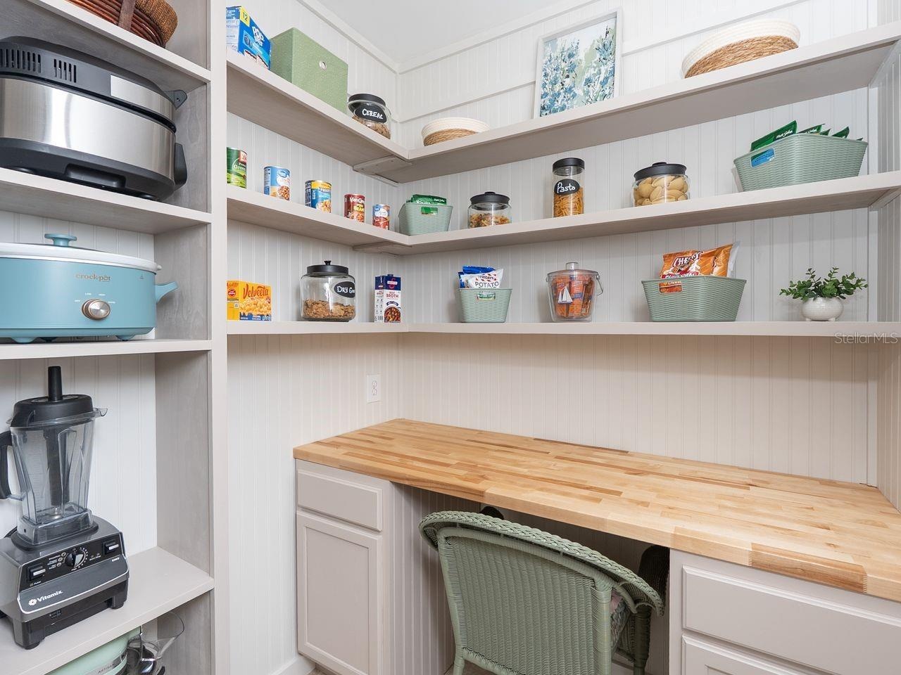 walk in pantry and small appliance closet with built in desk