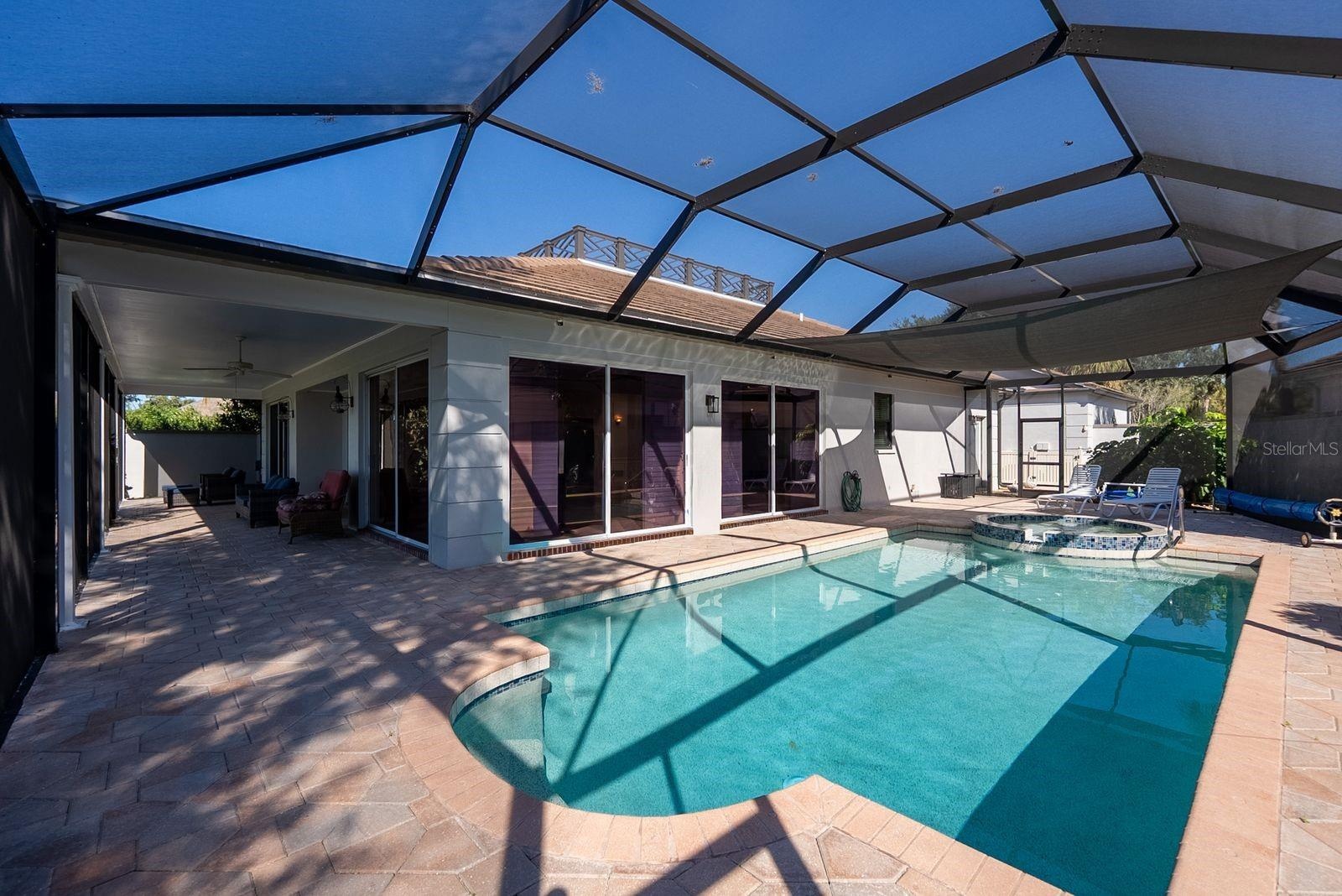 Pool area patio on side wraps around to back patio