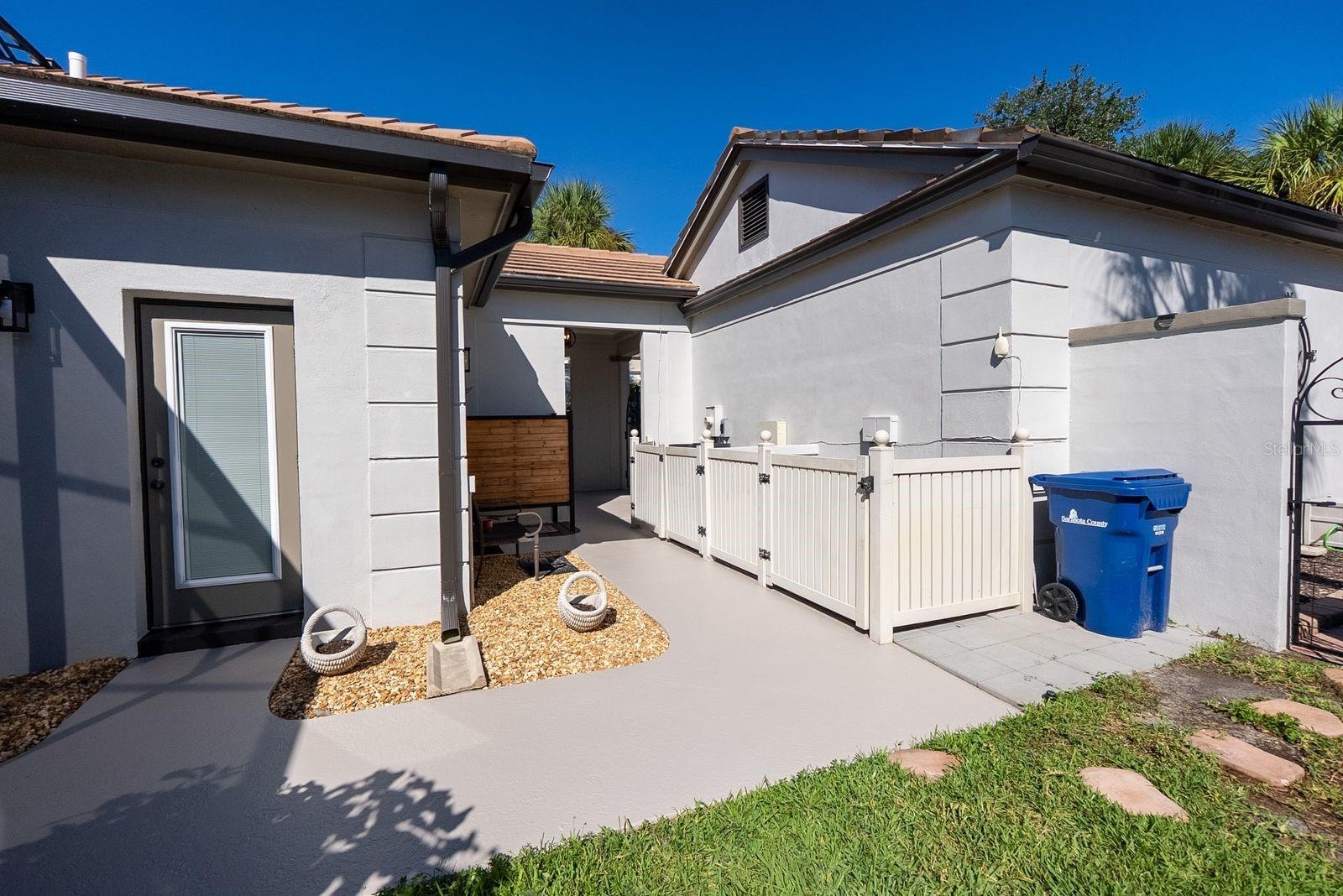 side of house showing door to 1/2 bath