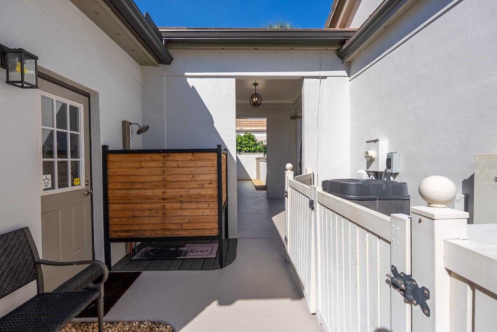 Outside shower by laundry room door on side of house