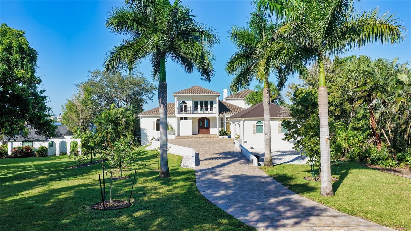 Looking at the property from the private road, fruit trees line the paved driveway