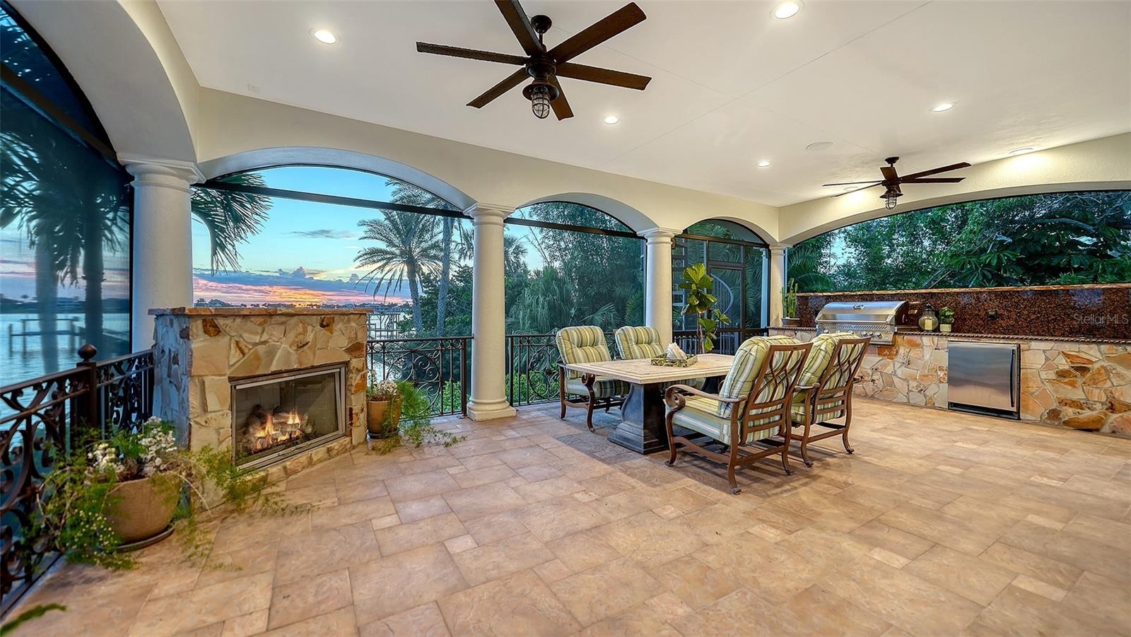 Outdoor living off the family room, with screening so no bugs allowed in while dining or relaxing by the gas fireplace