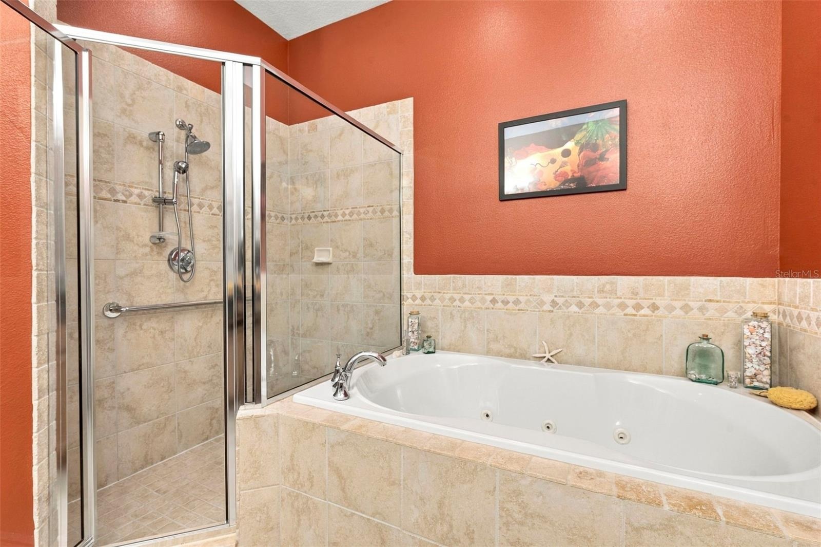 Primary Bedroom with En-Suite Bathroom, His & Her Walk-in Closets, Double sinks with Granite countertops, jacuzzi tub, separate shower