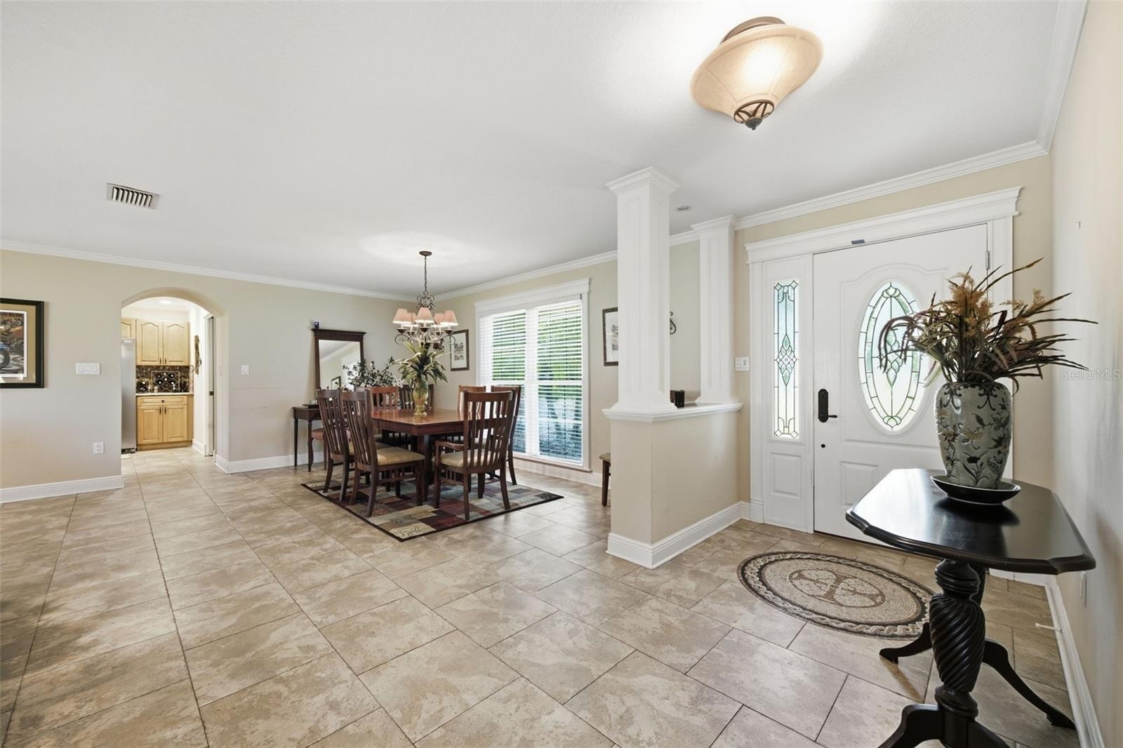 Welcoming foyer opens up to formal dining and family room