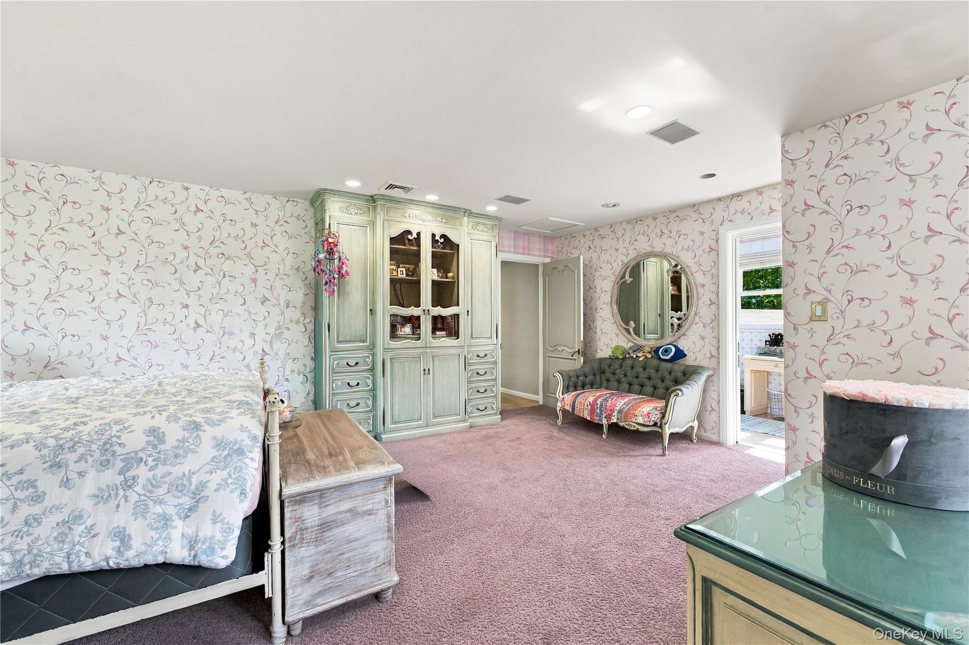 Built-in floor-to-ceiling cabinetry, recessed lighting, and patterned wall coverings