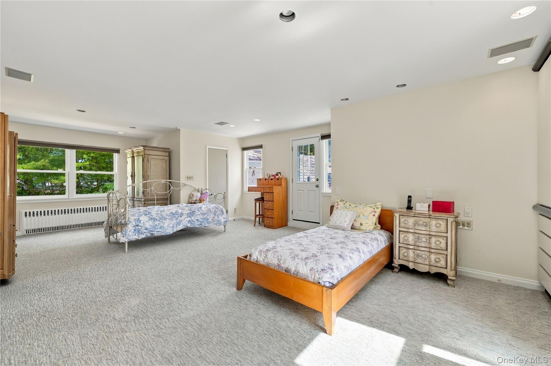 Spacious interior featuring wall-to-wall carpeting, recessed lighting, and a multi-pane glass door leading to the exterior