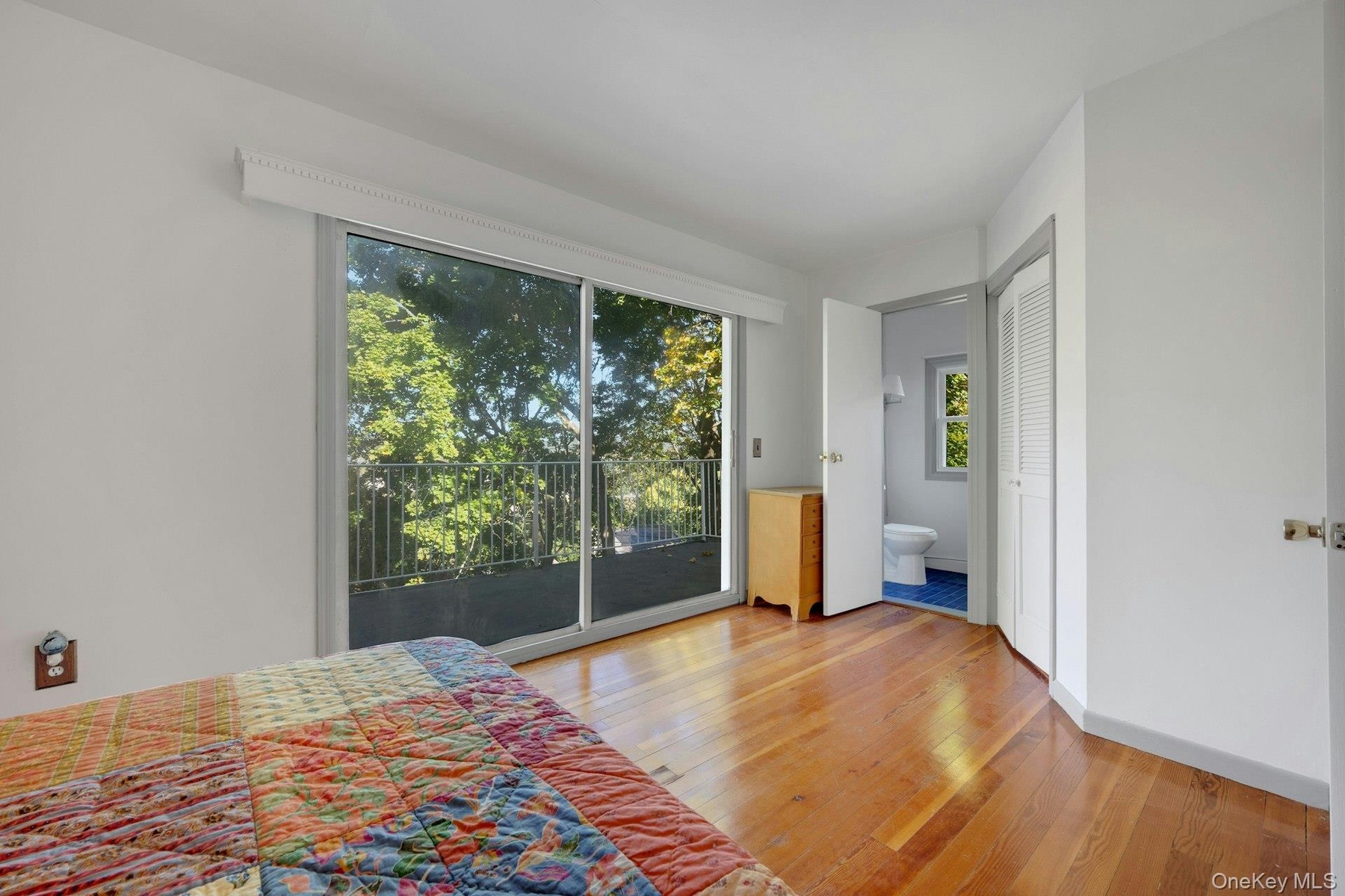 The Primary Bedroom has sliding glass doors that go out to a second floor porch