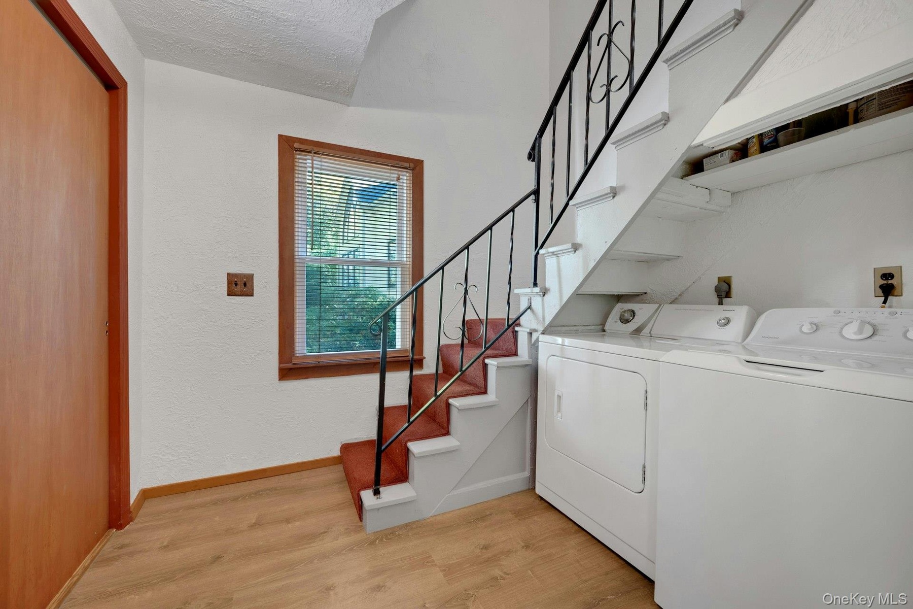 The double closet and washer / dryer are located in the hallway along with the staircase that goes up to the second floor bedrooms.