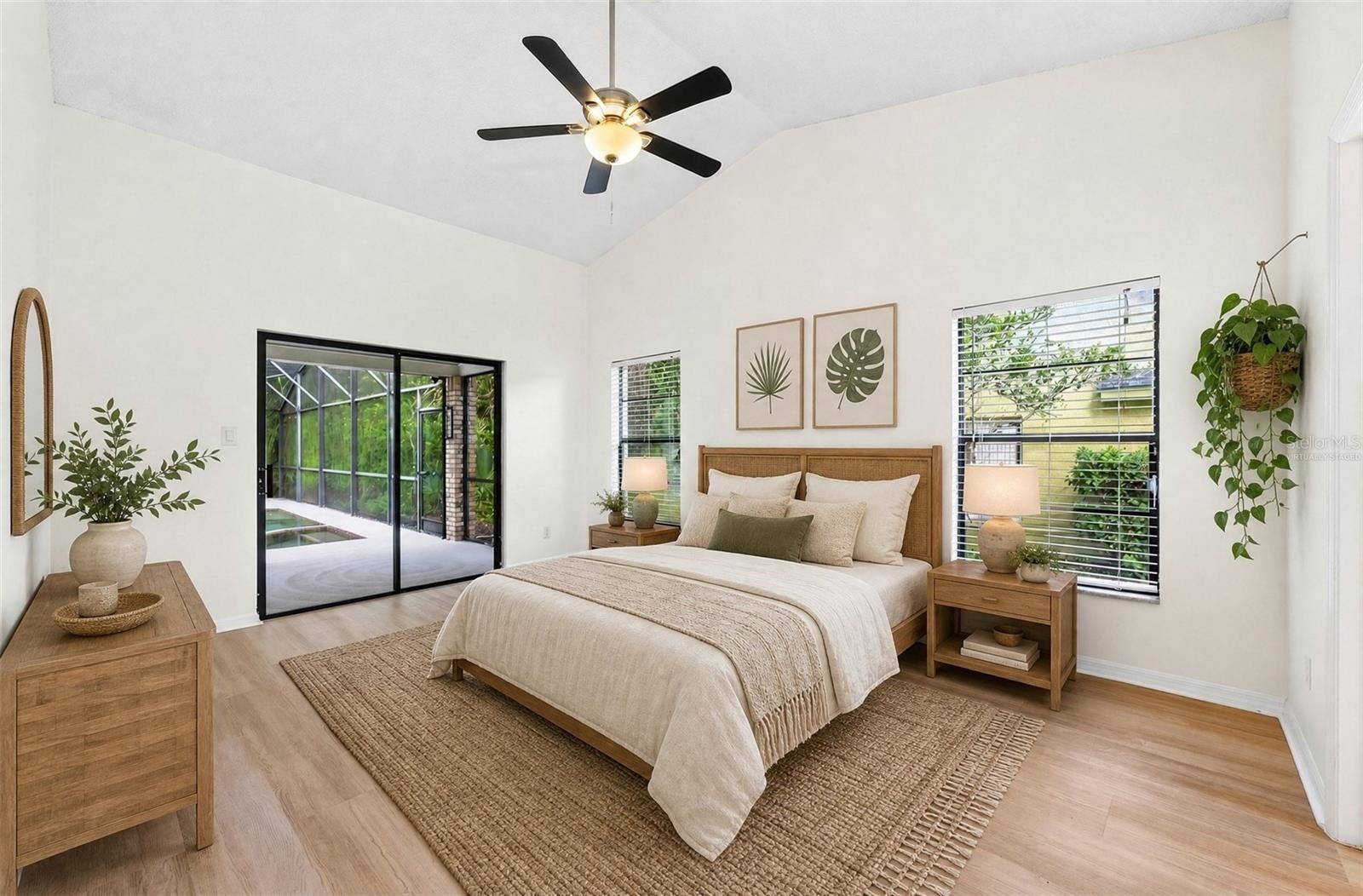 The spacious Primary Suite is filled with NATURAL LIGHT and features sliding glass doors that open directly to the pool and patio. Virtually Staged
