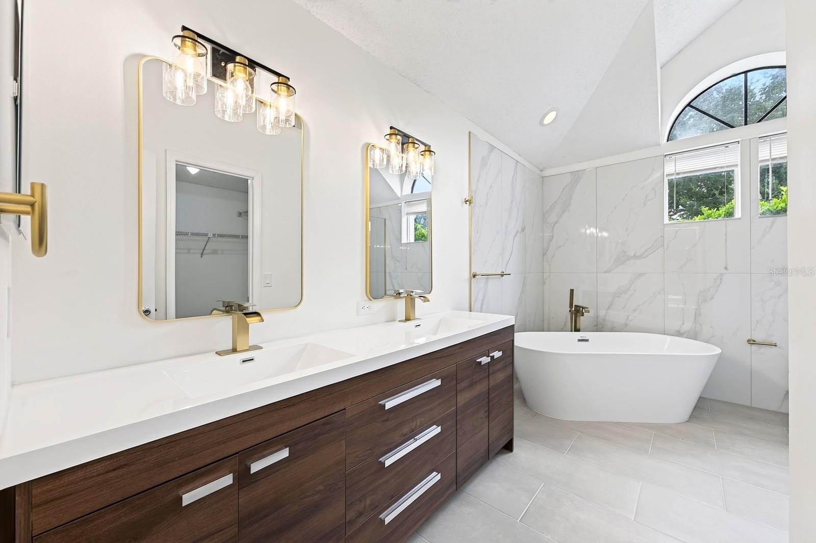 The Primary en suite Bath has been COMPLETELY UPDATED IN 2026 with dual sinks, a garden tub, a step-in shower and stylish MARBLE-LOOK tile walls.
