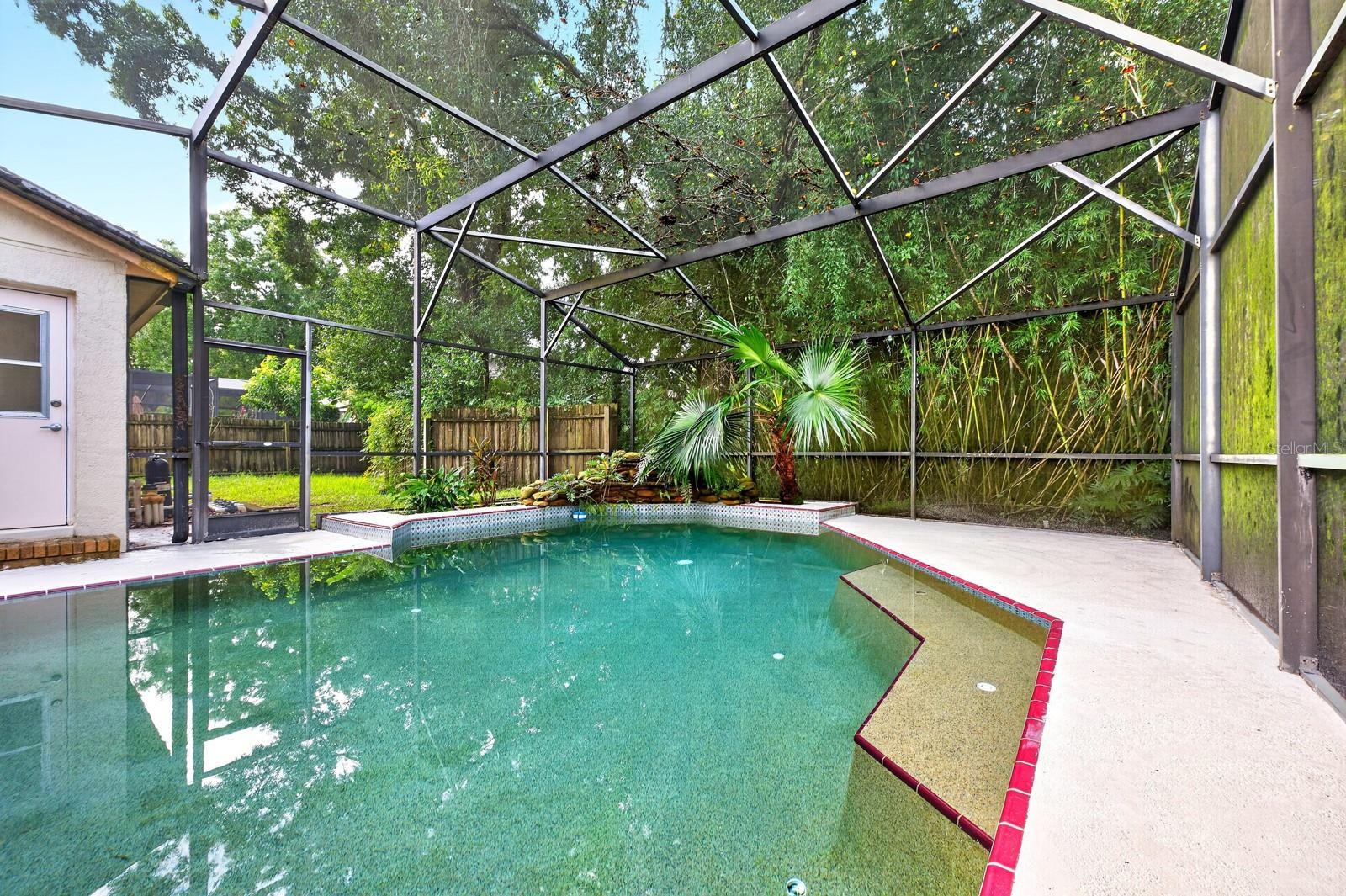 The in-ground pool and screened lanai create the perfect setting for swimming, relaxing and entertaining year-round.