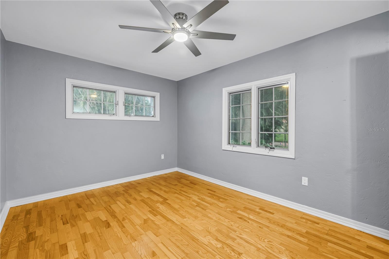 Spacious second bedroom with energy-efficient dual-pane windows, natural light, noise reduction, private half bathroom, and an expansive walk-in close