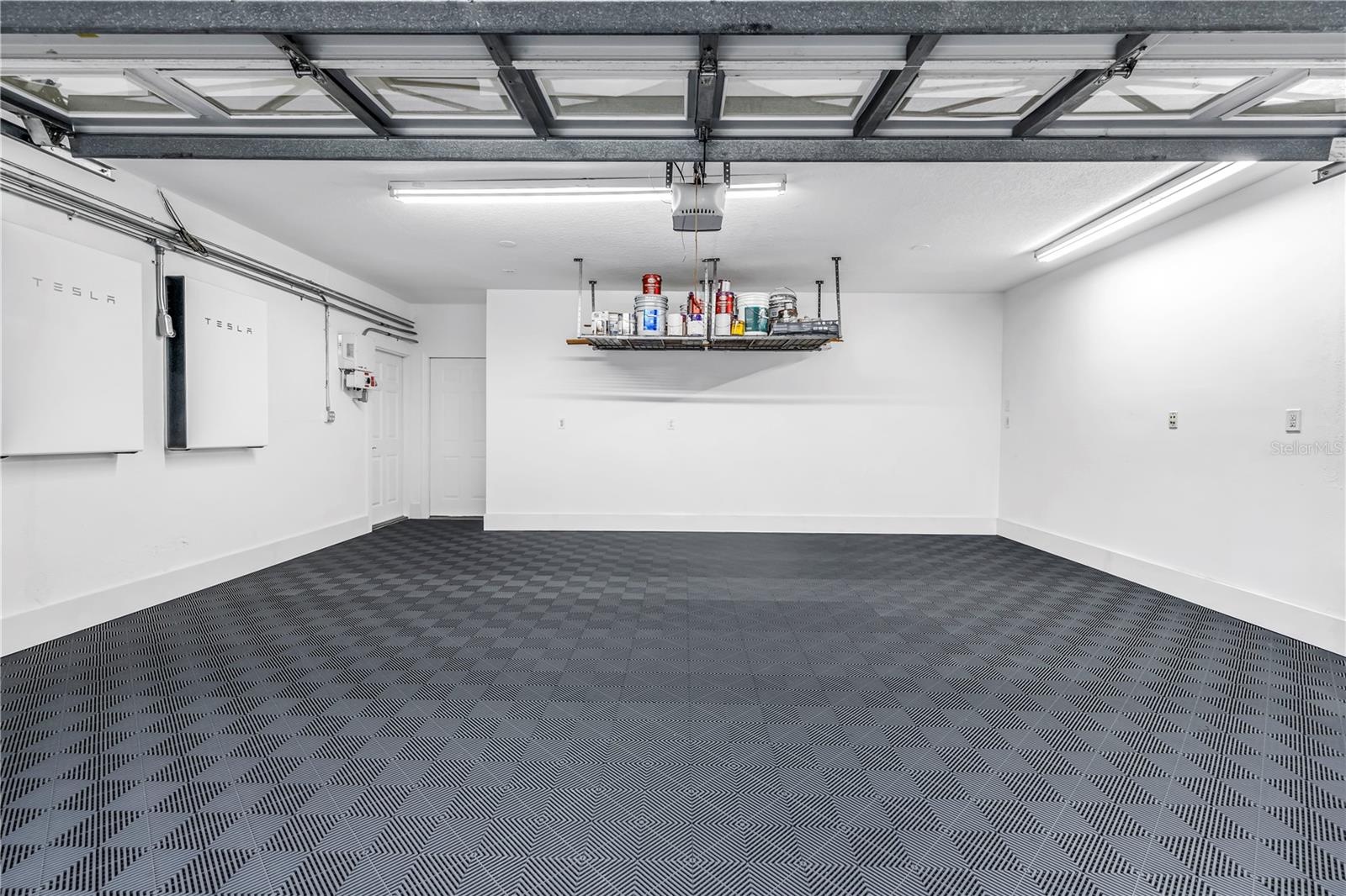 Pristine Garage Space with heavy duty matting for cars, workout or projects