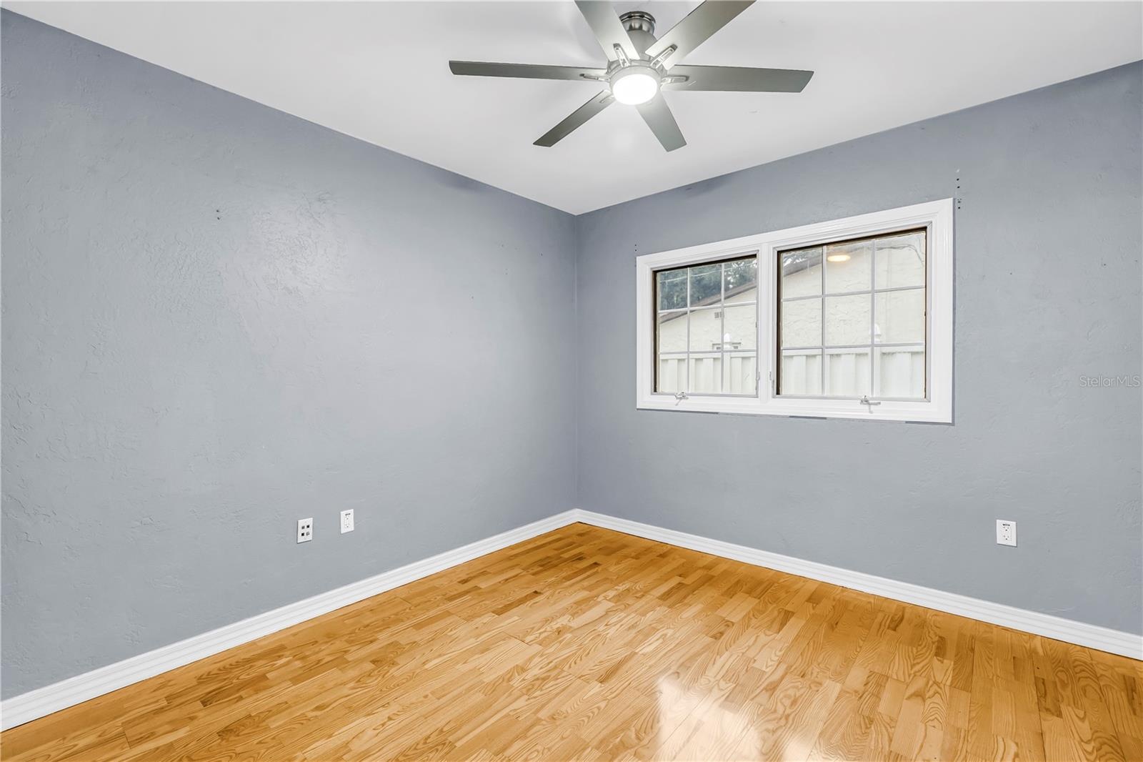 Third bedroom featuring a window and a large closet.