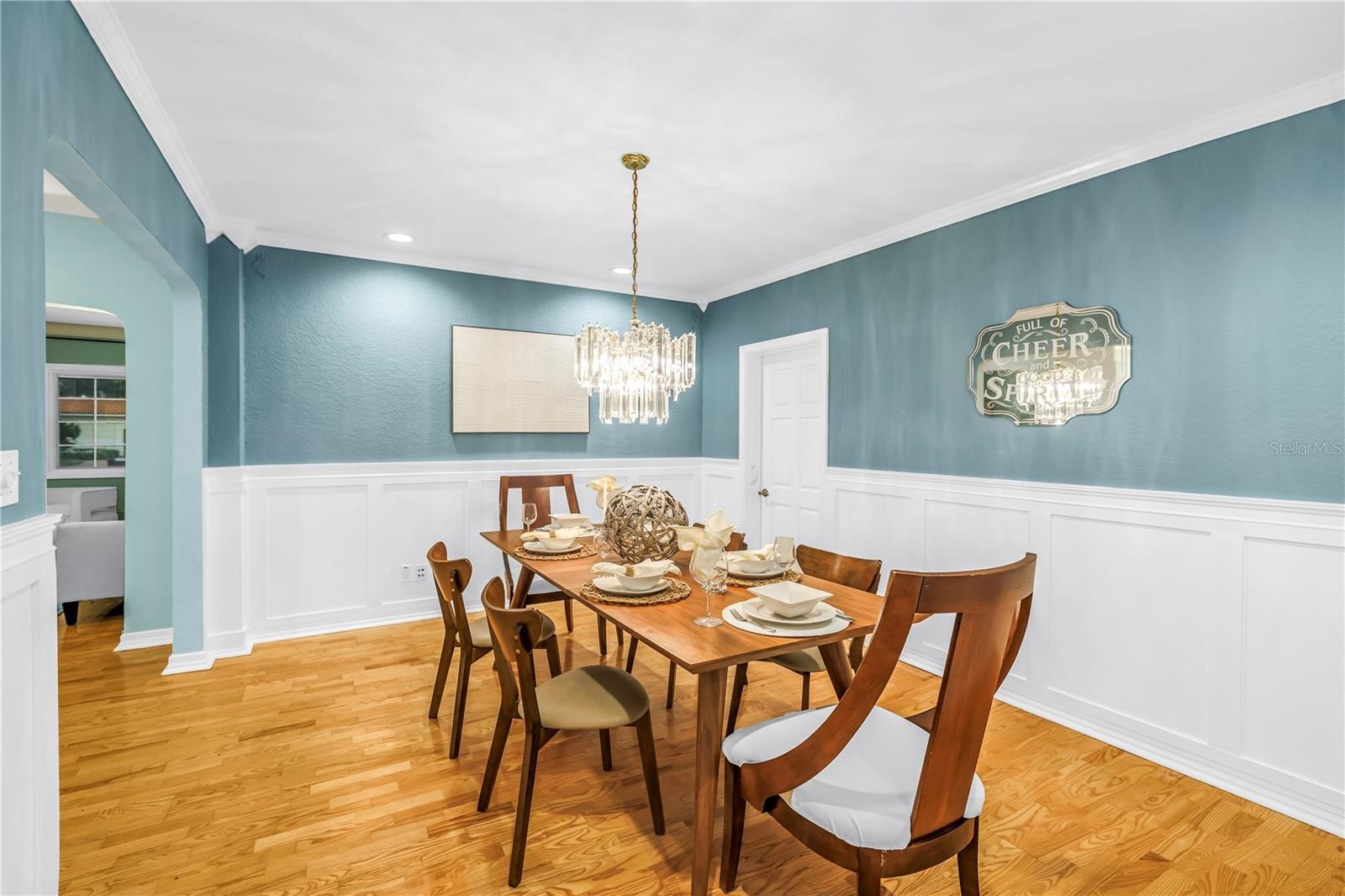 Hand-crafted wainscoting and crown molding elevate this spacious, accommodating formal dining room—perfect for hosting holiday gatherings.
