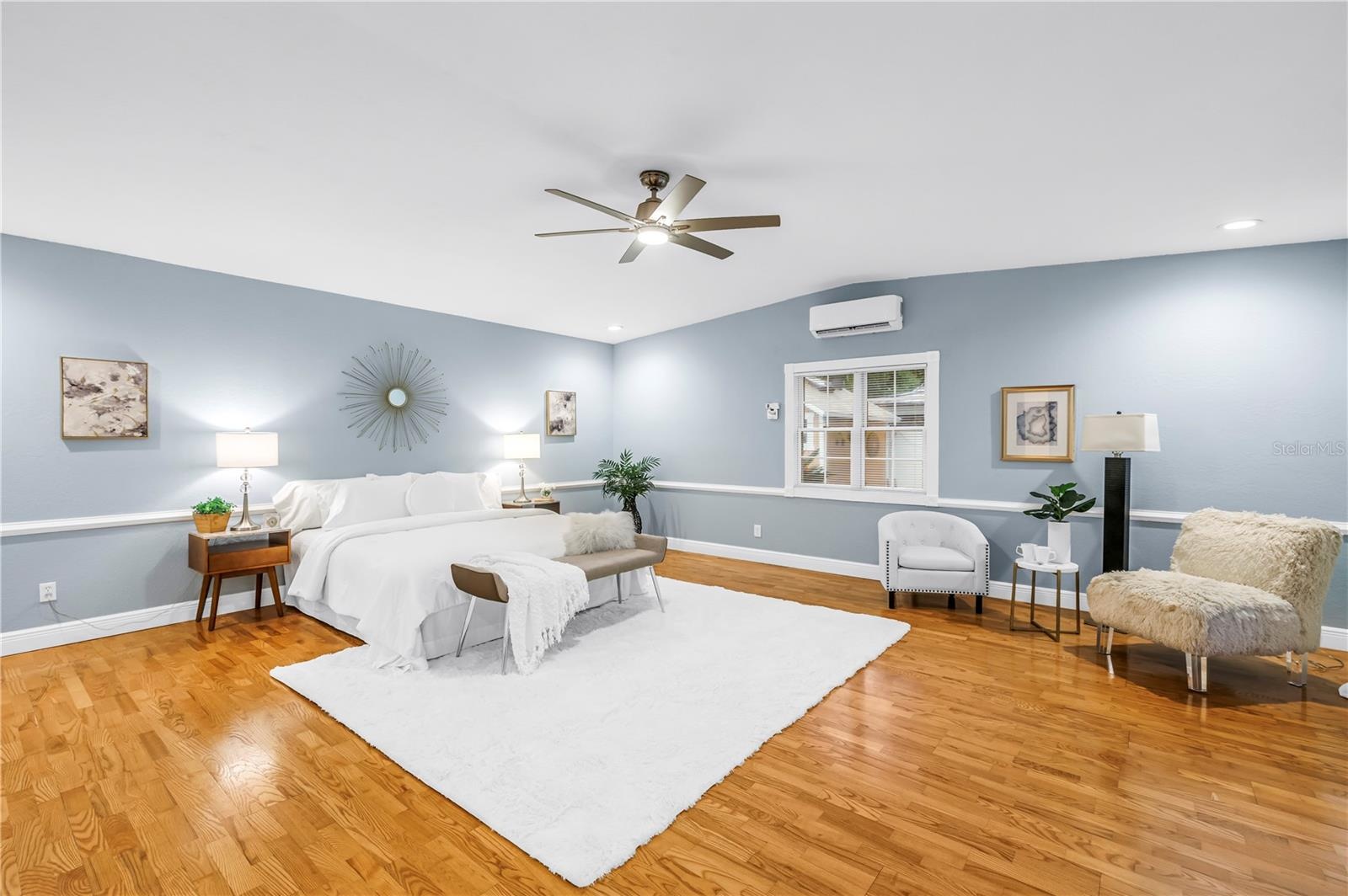 Primary Bedroom has window, French Doors to the pool and additional cooling for the perfect night's sleep.  Room also cooled by Central HVAC