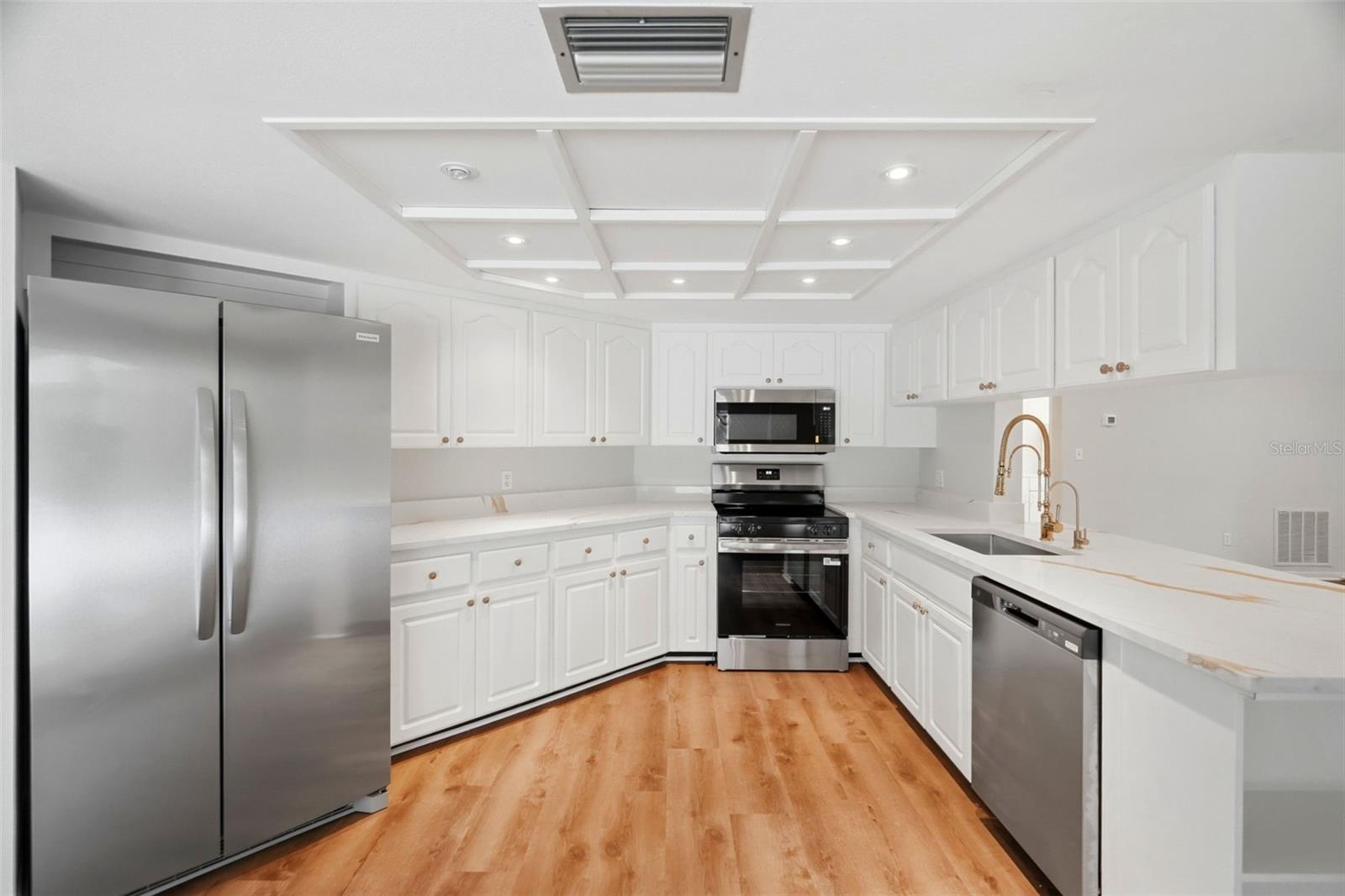 Recently refreshed with new quartz countertops, fixtures, and painted wood cabinetry.