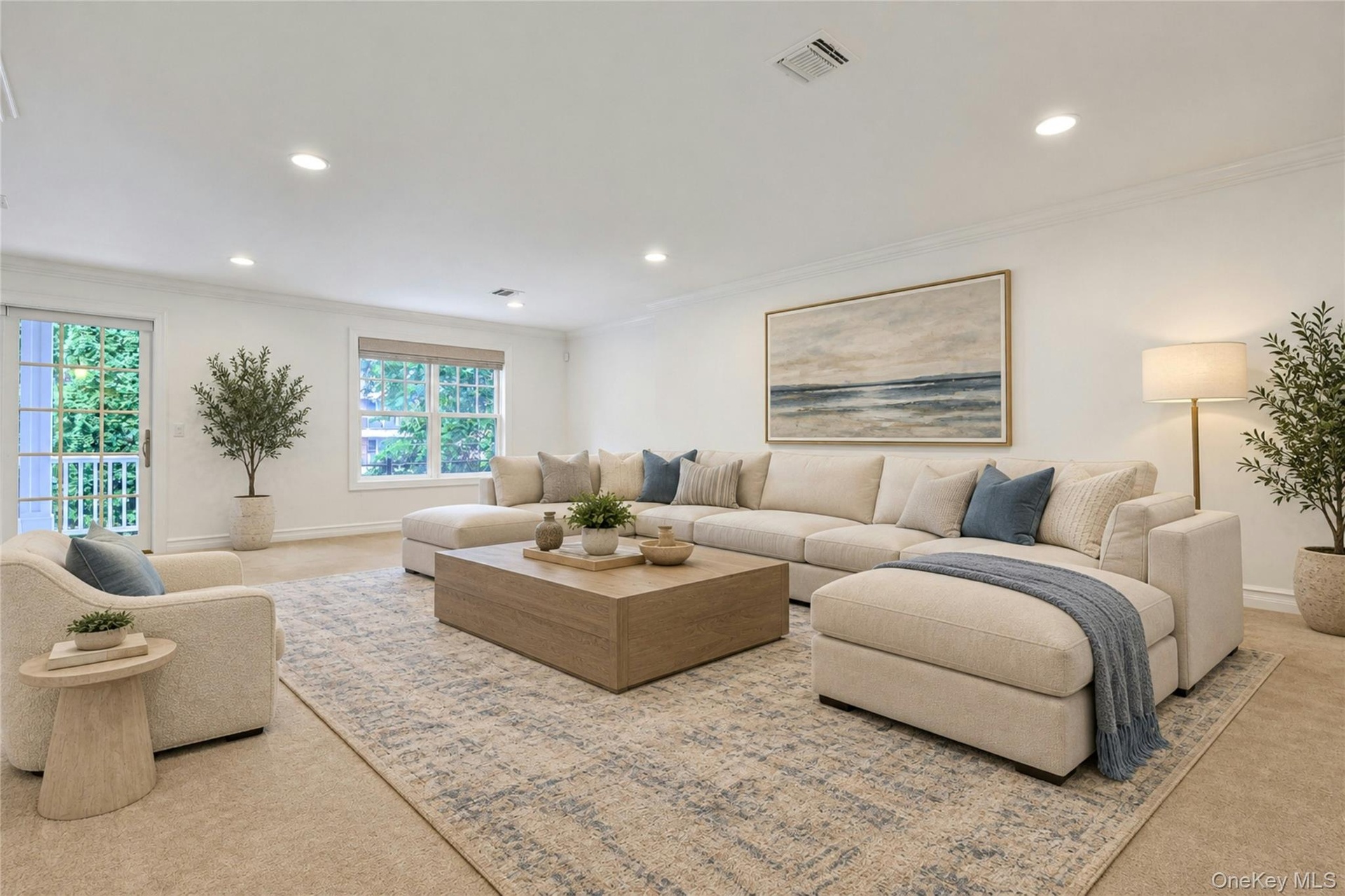 Bright and spacious with recessed lighting and oversized windows, this versatile lower-level living space is ideal for entertaining, relaxing, or work