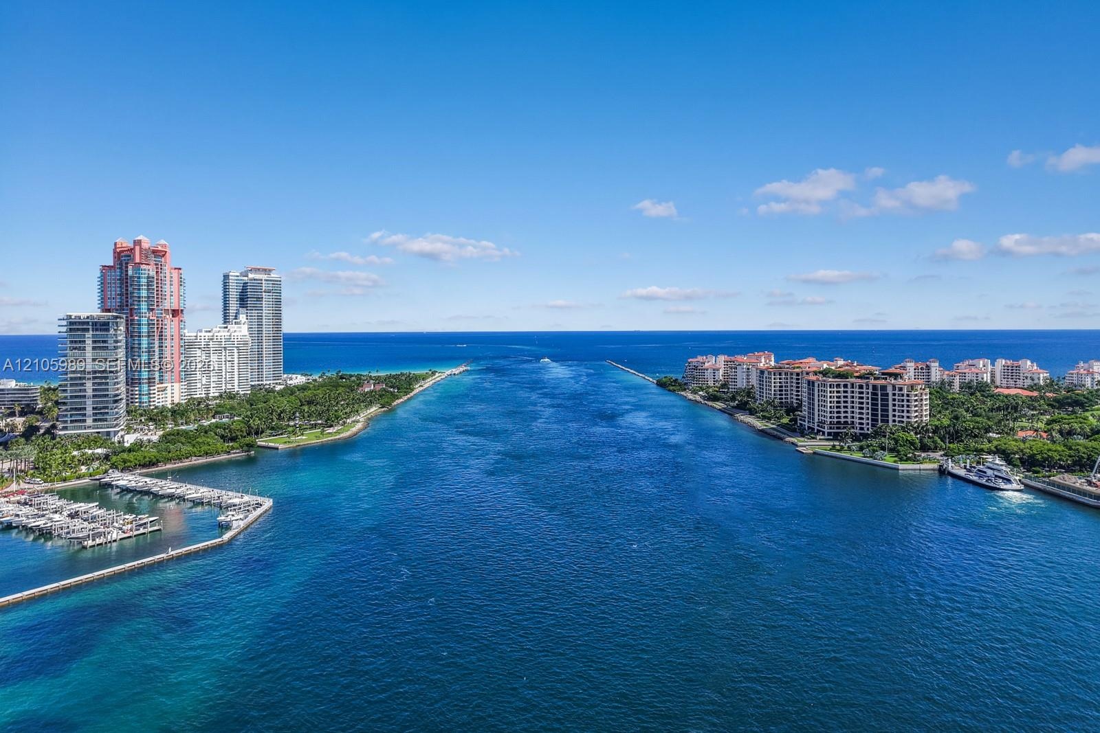 Aerial perspective of the waterway and coastal inlet featuring open ocean access, deep-water channel, and surrounding high-rise infrastructure