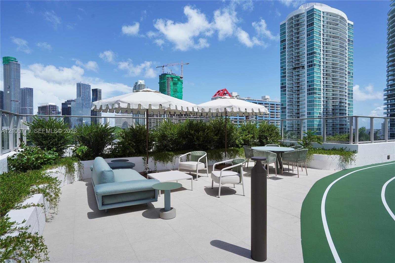 Rooftop terrace featuring concrete-tile flooring, a dedicated running track, glass perimeter railing, and integrated planters