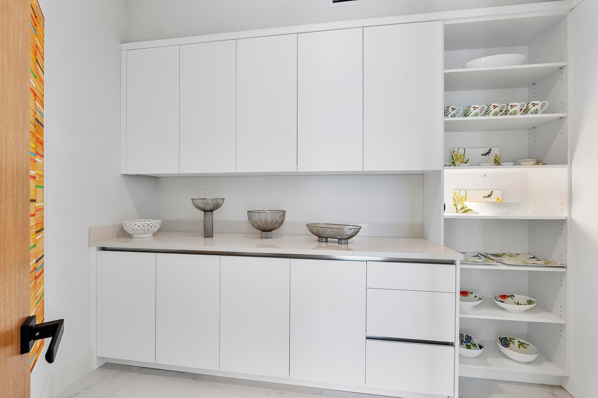 A dedicated, custom-shelved China Closet beautifully houses fine china, crystal, glassware and treasured collections—an exceptional detail for those w