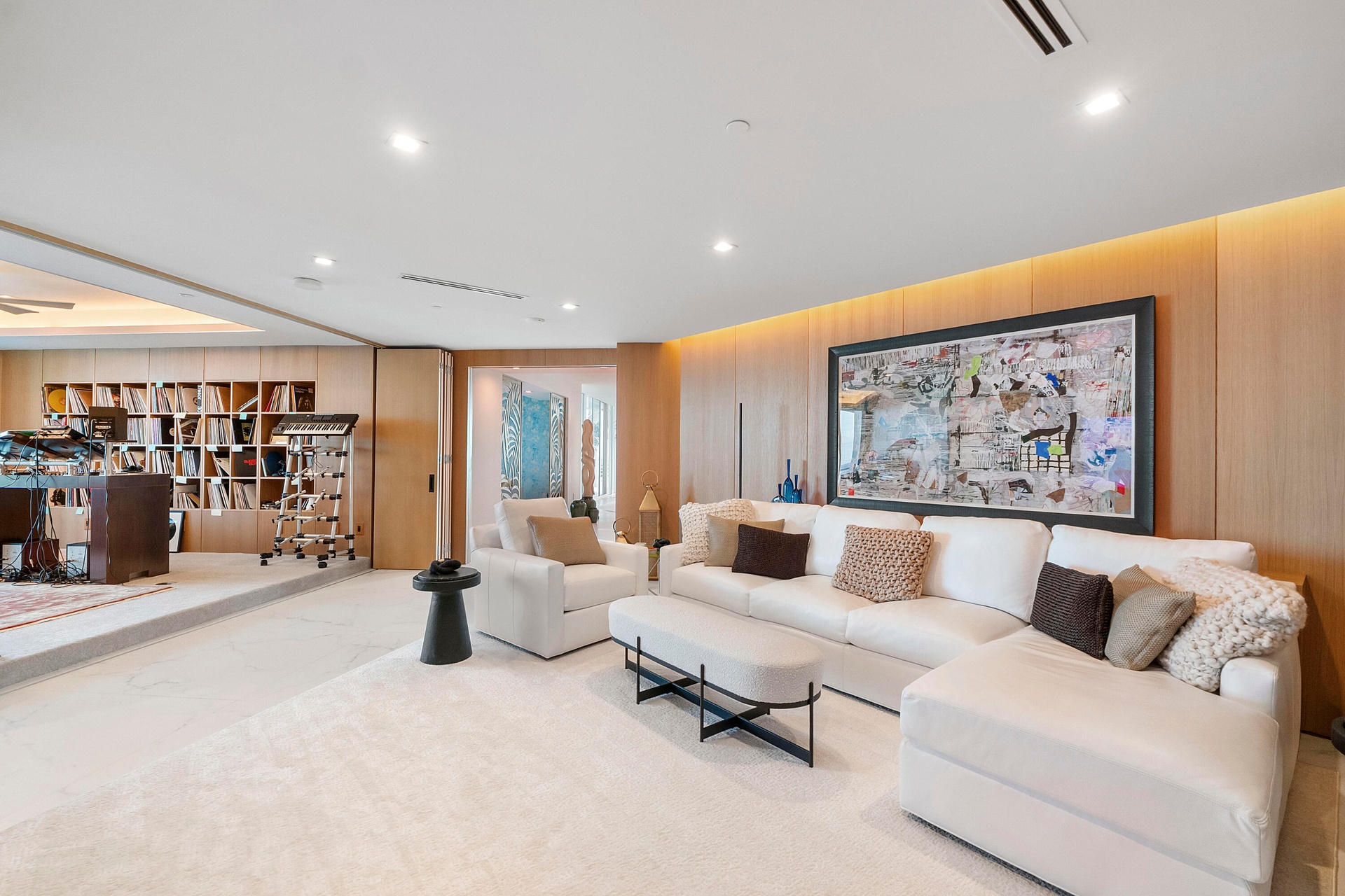 A Private Living & Creative Suite — Here, the ingenuity of the floor plan truly reveals itself. The white-oak-clad living room flows directly into an 