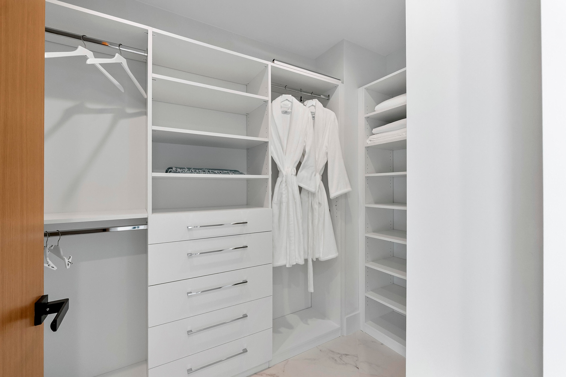 A Boutique-Style Private Dressing Room — The Aqua Guest Wing includes its own beautifully fitted walk-in dressing room, with extensive custom shelving