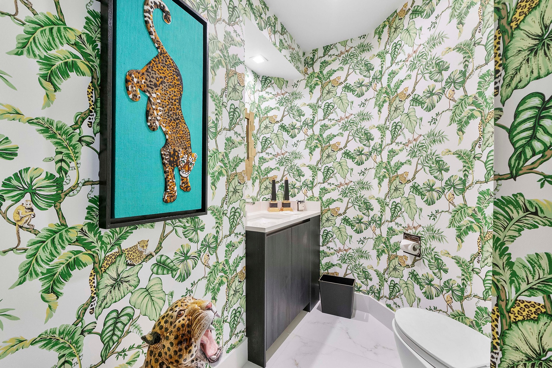 A hidden jewel at the end of the tropical hallway, this exceptionally private powder room is a delightful departure from the expected. Dramatic custom