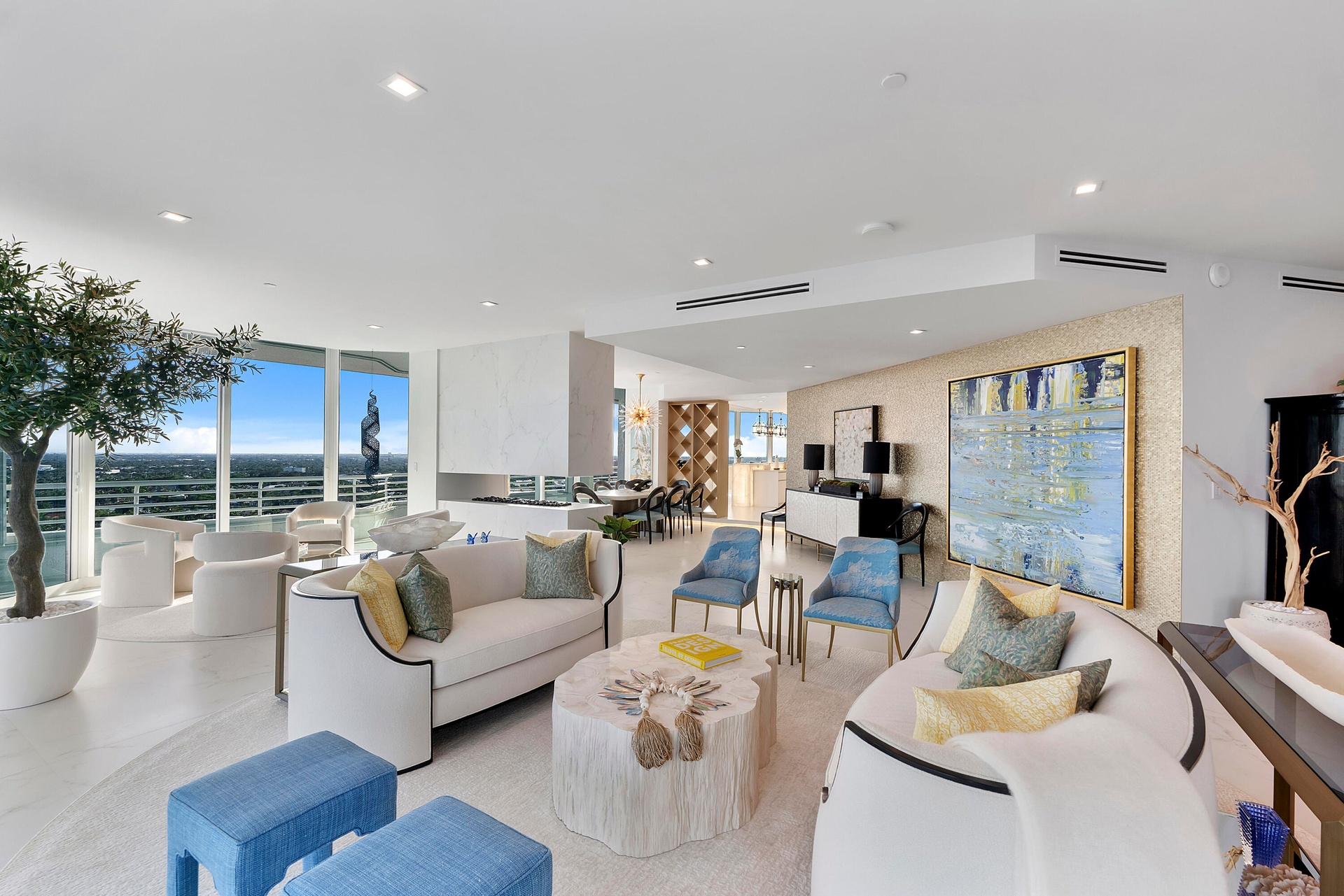 A magnificent custom golden metallic feature wall transforms the curving gallery into an architectural work of art, shimmering behind the oversized ar