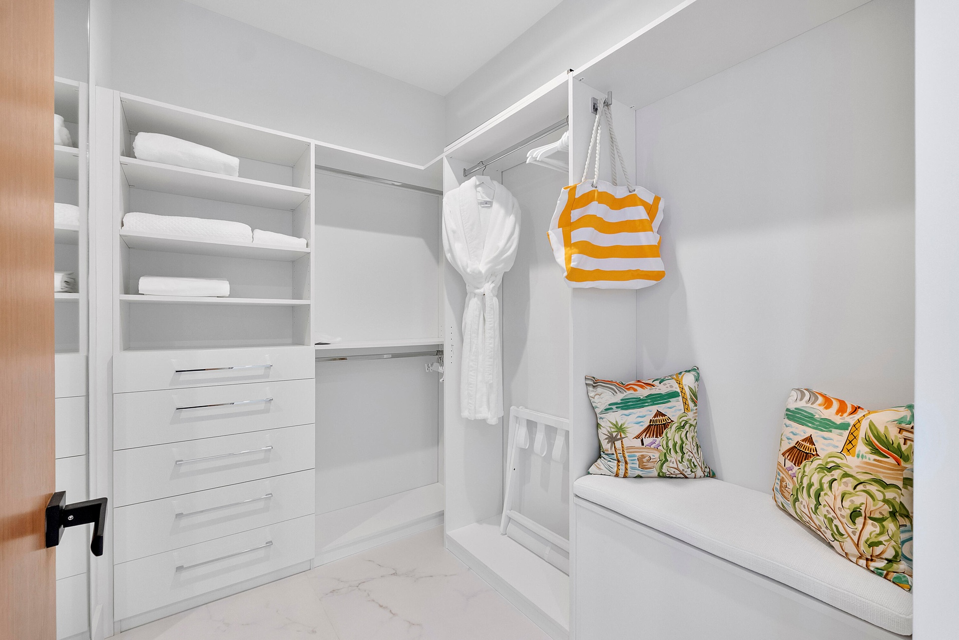 Completing the suite is its private custom-fitted dressing room, beautifully organized with extensive built-in shelving, drawers, hanging space and a 