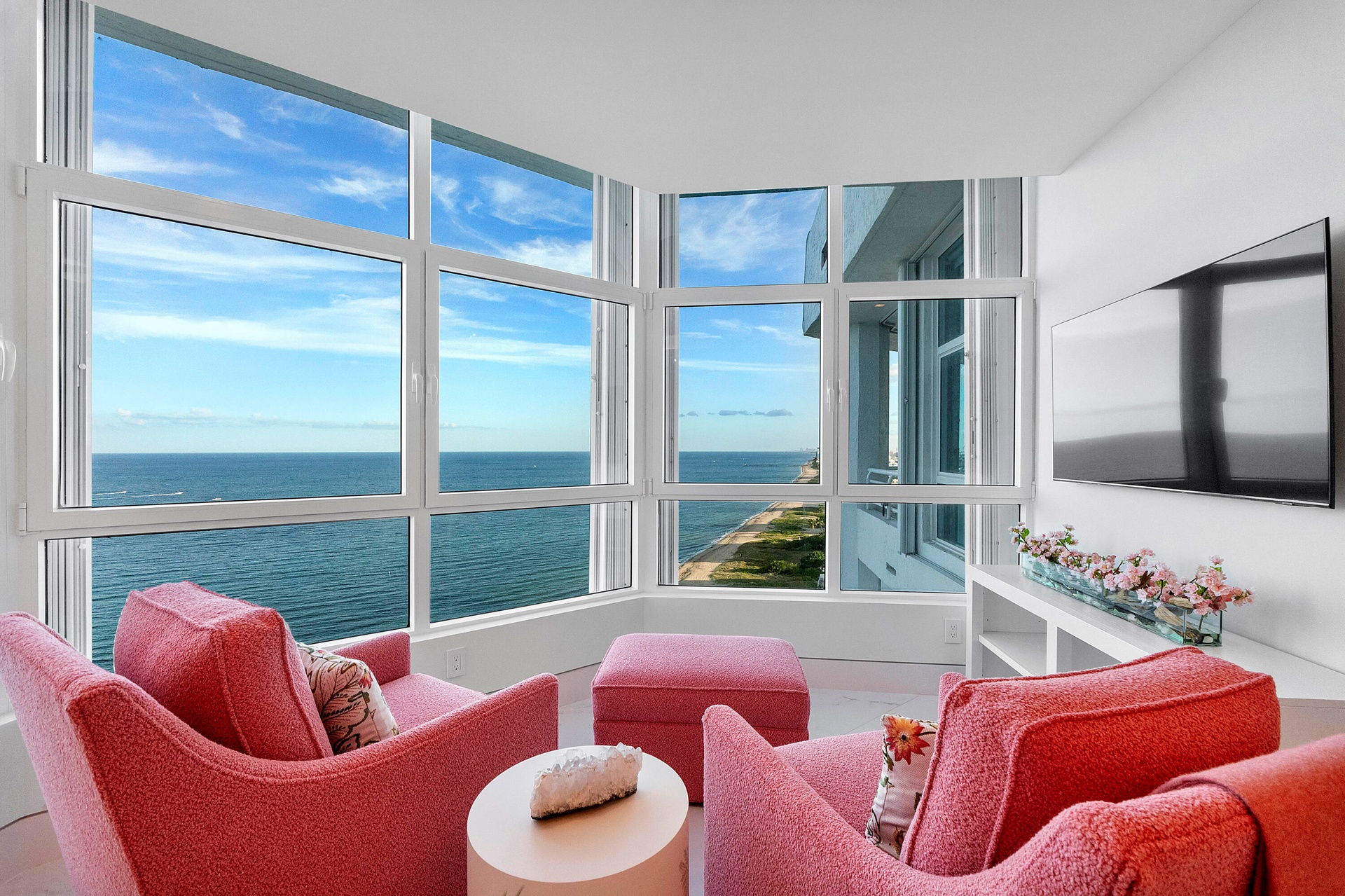 Nestled within The Rosewood guest room, this enchanting private lounge occupies the front bay of the penthouse, where floor-to-ceiling glass surrounds