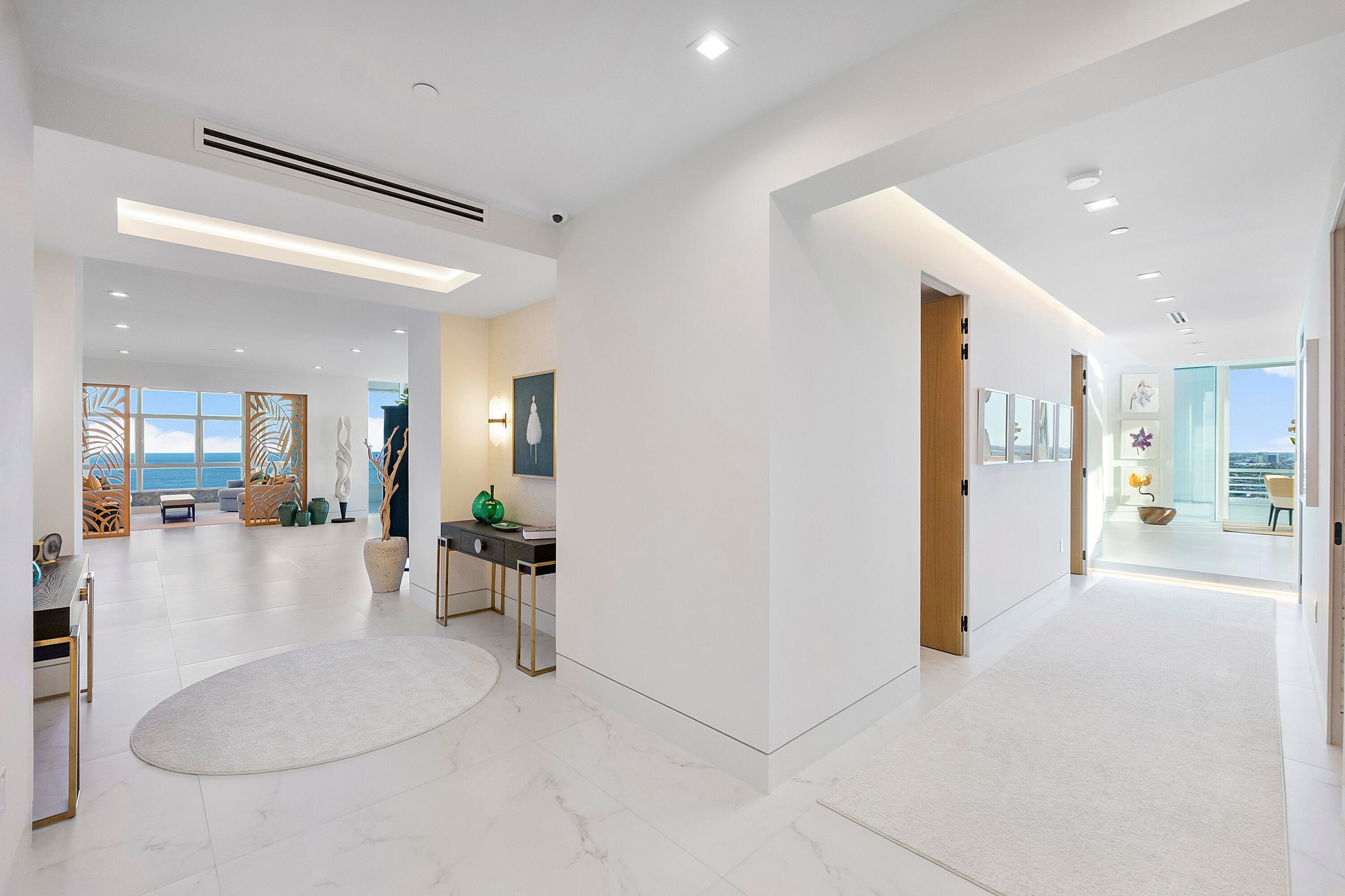 A dramatic split foyer welcomes you through carved-wooden double entry doors, where two gallery-style hallways gracefully divide the residence into it