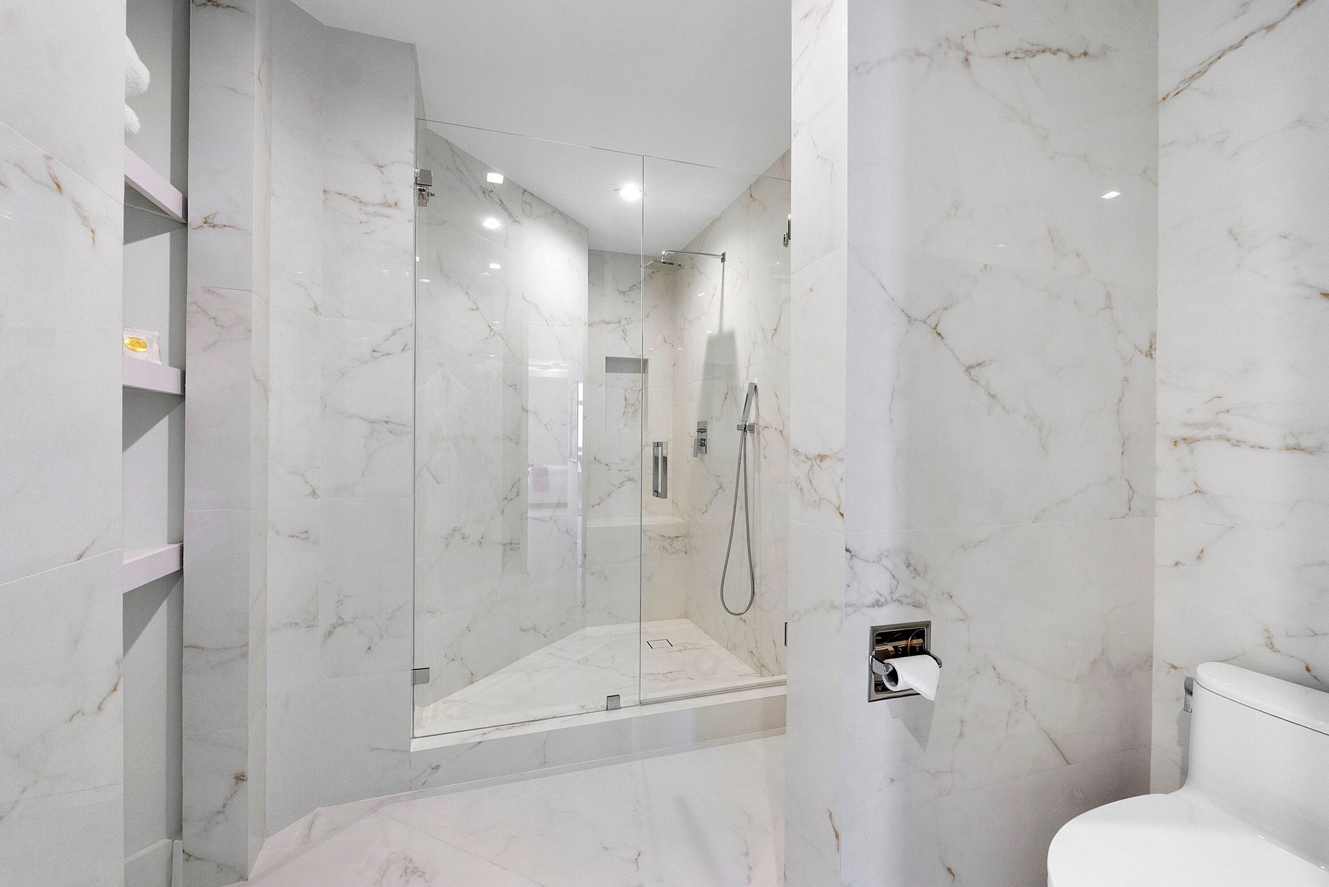 clean modern sculptured shower and towel shelving with LED lighting throughout