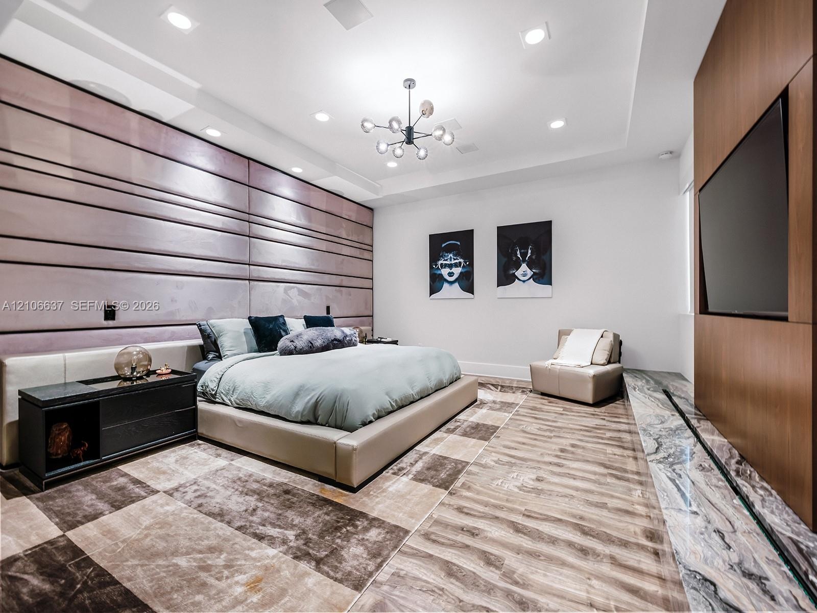 Large-format tiled flooring, recessed ceiling lighting, multi-arm modern chandelier, paneled wall feature, and built-in wood-finish media wall