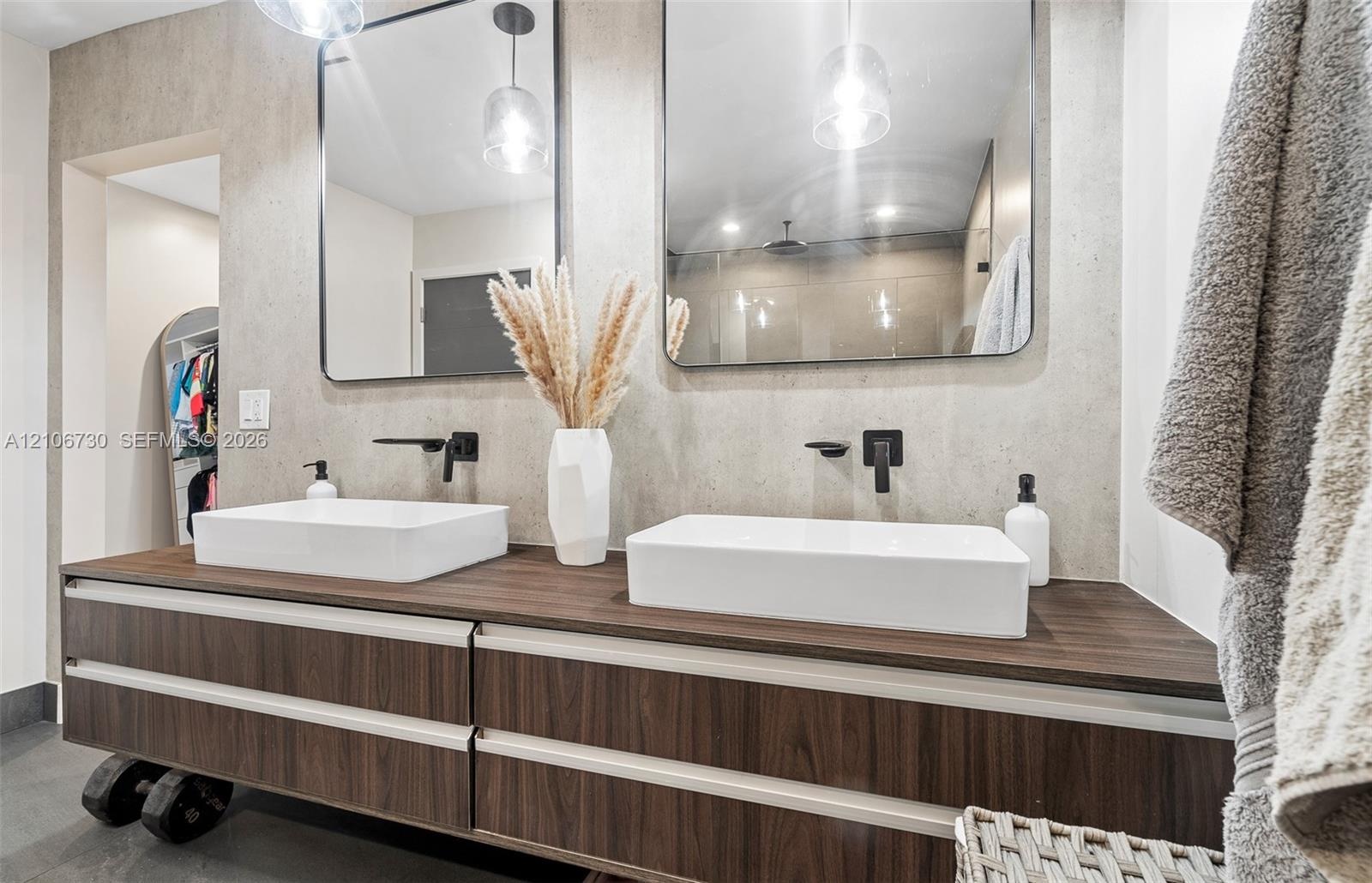 Floating wood-finish vanity with dual rectangular vessel sinks, quartz-finish countertop, matte black wall-mounted faucets, and two rectangular mirror
