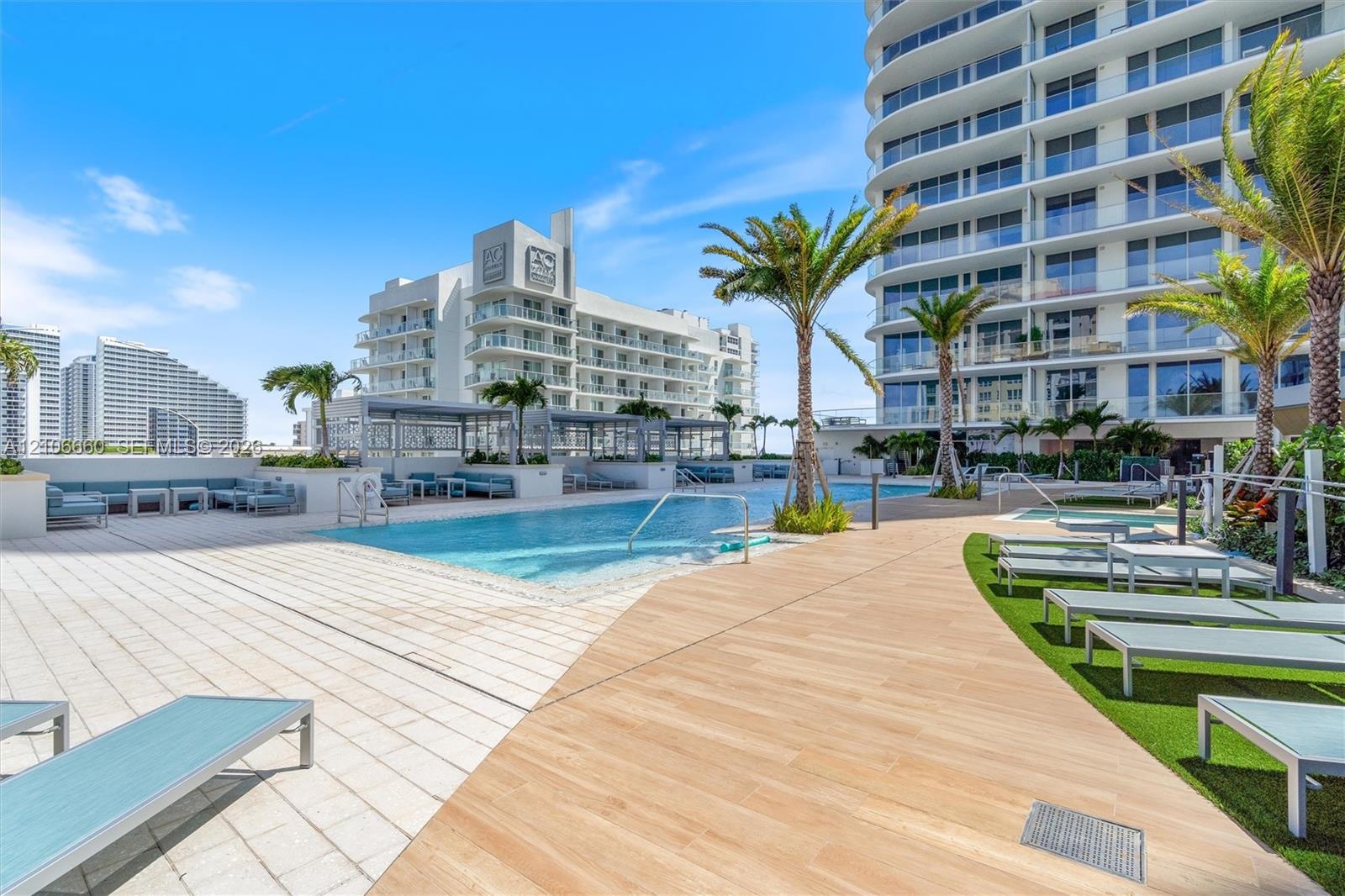 Swimming pool with a sun shelf, paved pool deck, wood-finish decking, integrated landscaping, and built-in pergola structures