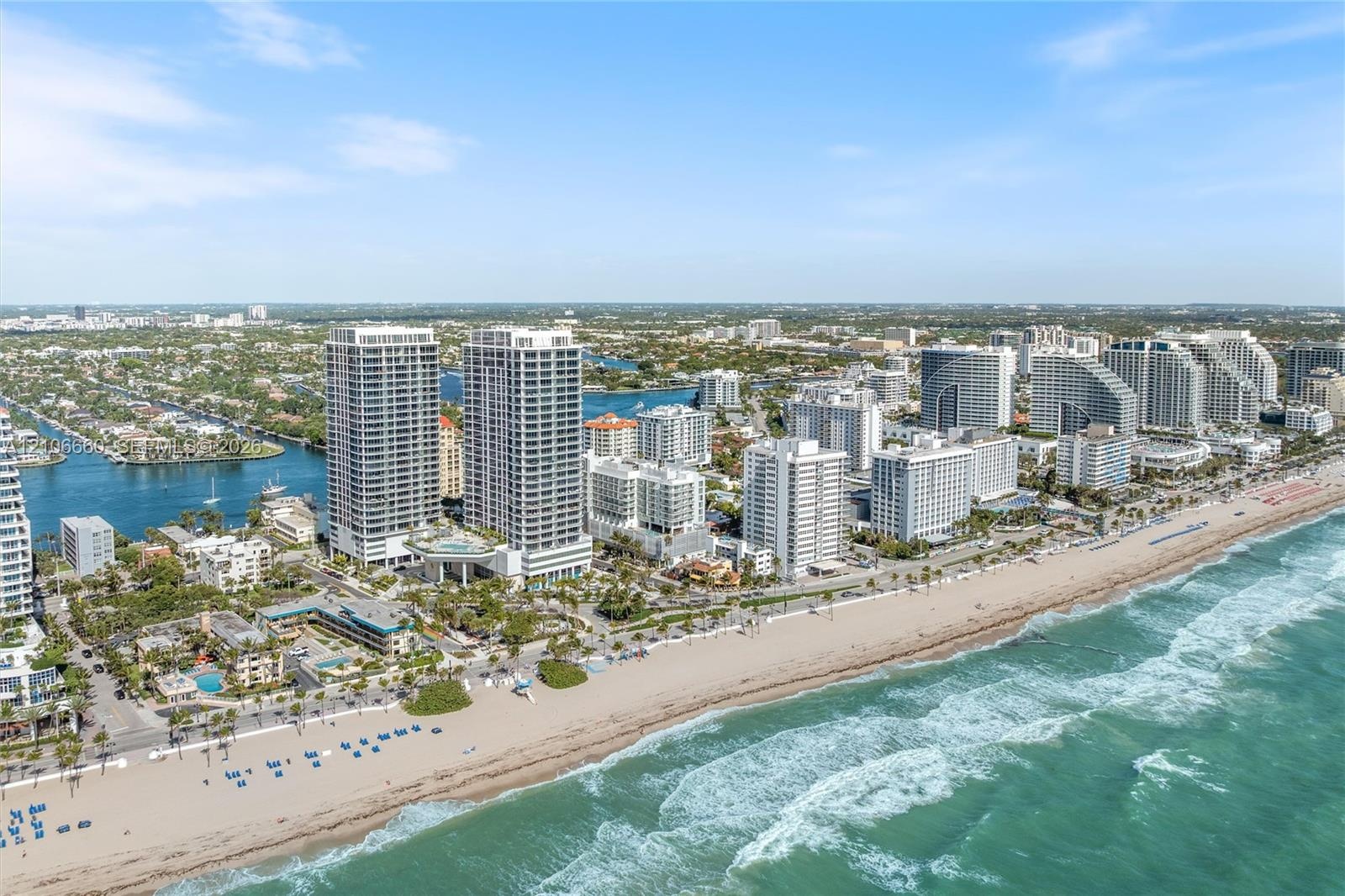 Aerial perspective of coastal high-rise development featuring direct proximity to the Atlantic Ocean shoreline, sandy beaches, and expansive waterfron