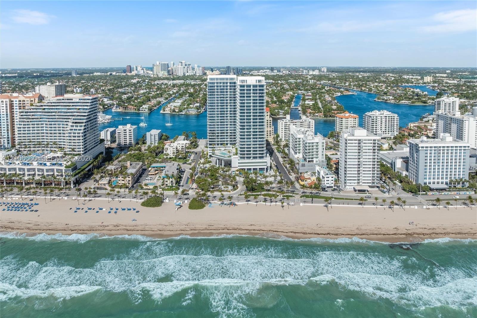 Aerial perspective of a coastal high-rise property featuring direct beach access, proximity to the Atlantic Ocean, and established waterfront surround