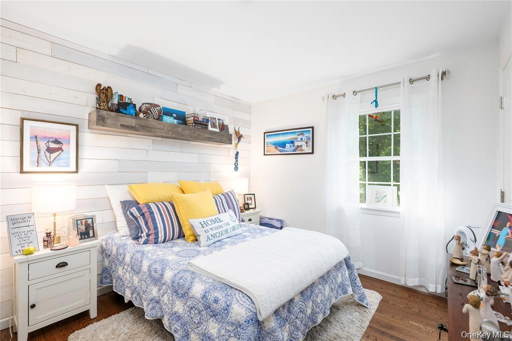 Shiplap wall, exusing warmth and style. Hardwood Floor.