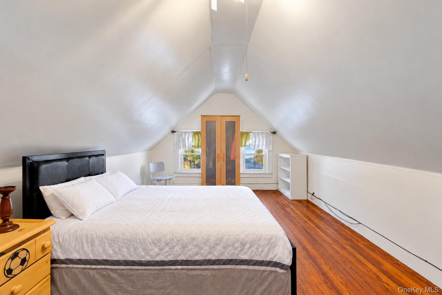 4th Bedroom on top floor with wood-finish flooring, and built-in cabinetry