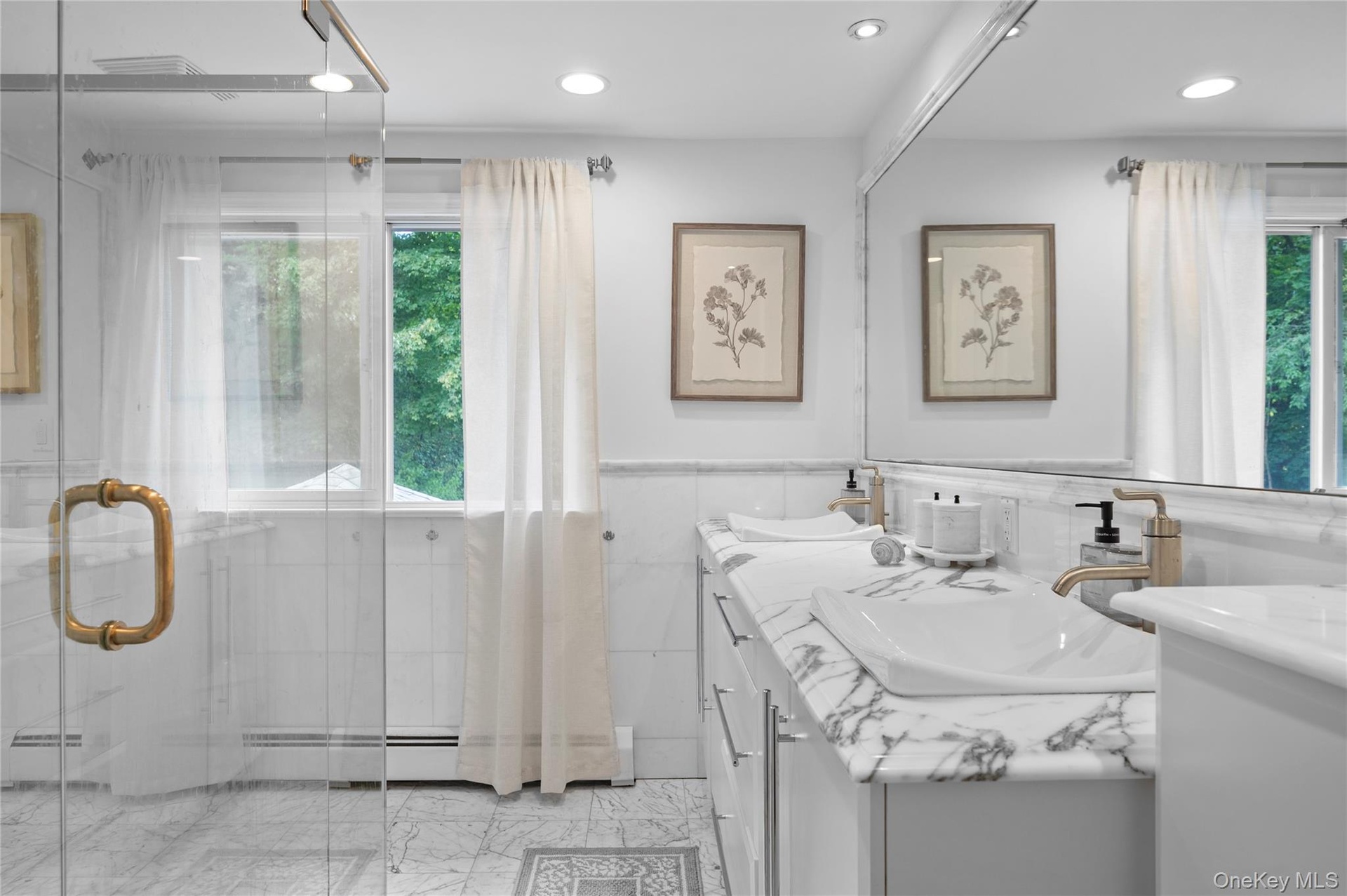 Bathroom featuring a glass-enclosed shower with brass hardware, vanity with stone countertop and integrated sink, recessed lighting, and stone-finish 