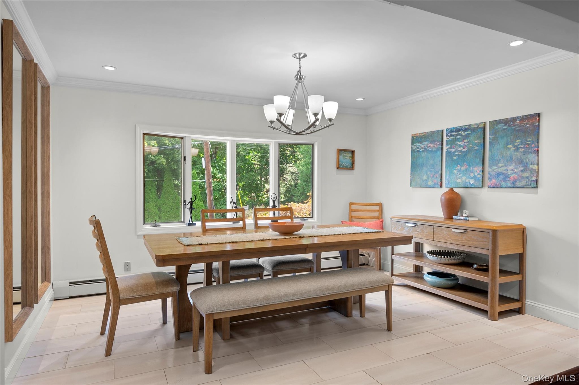 Dining area featuring light-toned flooring, multi-pane casement windows, a multi-arm chandelier, and crown molding