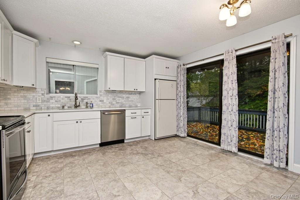 Quartz counters and marble backsplash in Kitchen