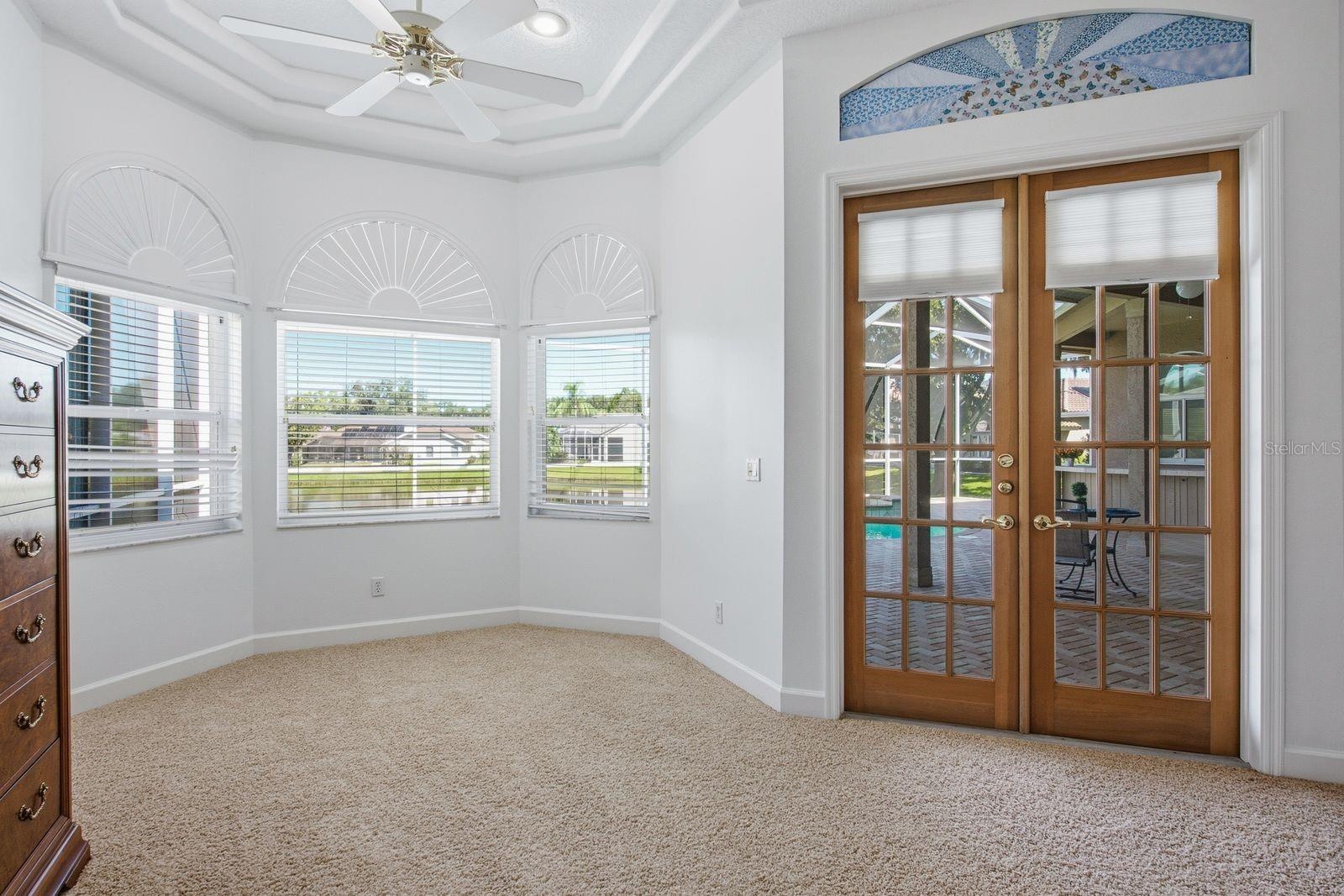Large Sitting Area in the Primary Bedroom with Bay Window and French doors leading to the Lanai
