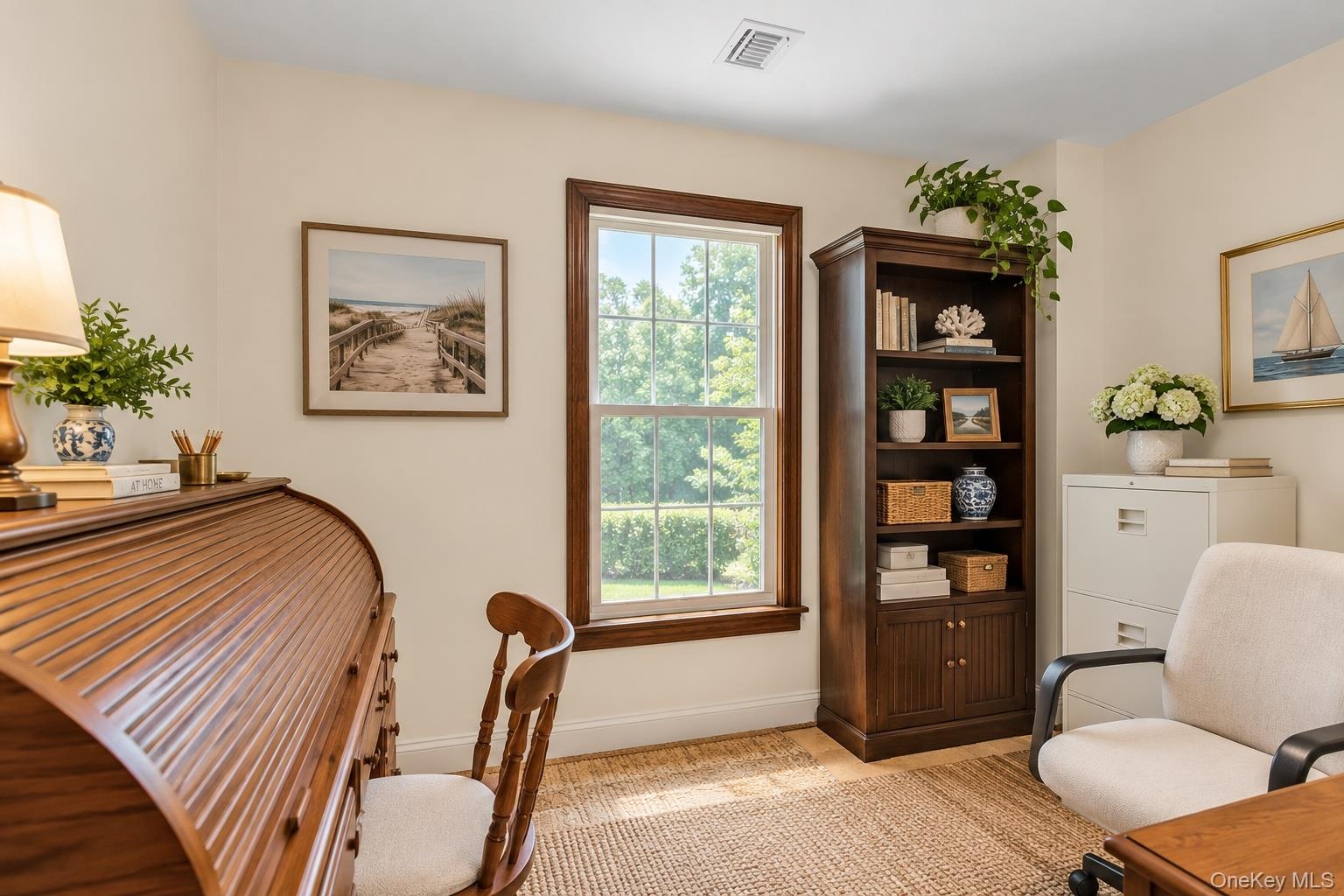 Room featuring neutral walls, wood-trimmed window, and wood-finish flooring