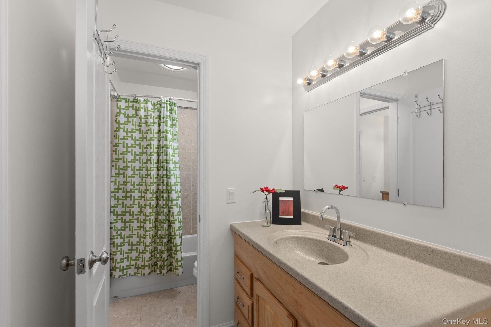 Thoughtfully designed to serve two upstairs bedrooms, this uniquely configured adjoining bath features separate entrances and individual vanities, off