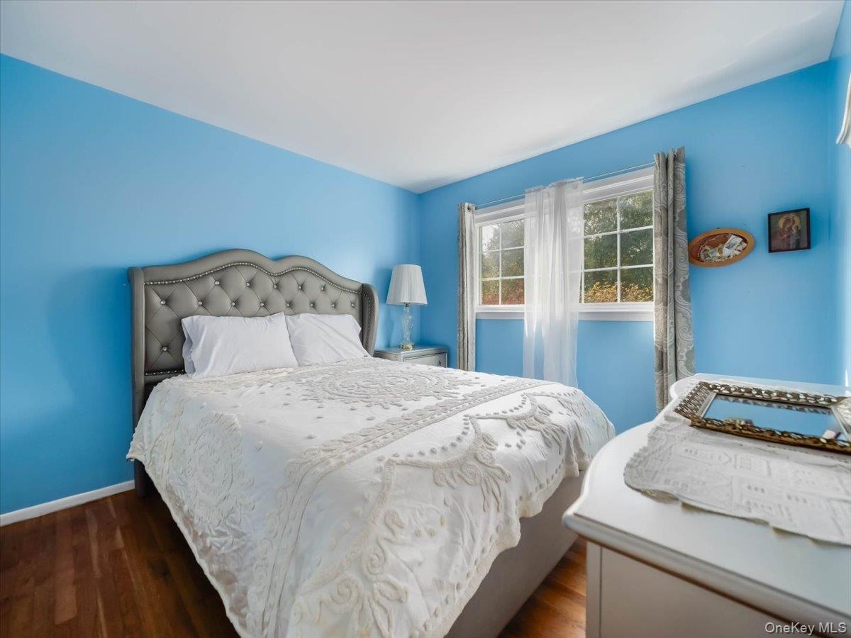 Room featuring wood-finish flooring and a multi-pane window with natural light